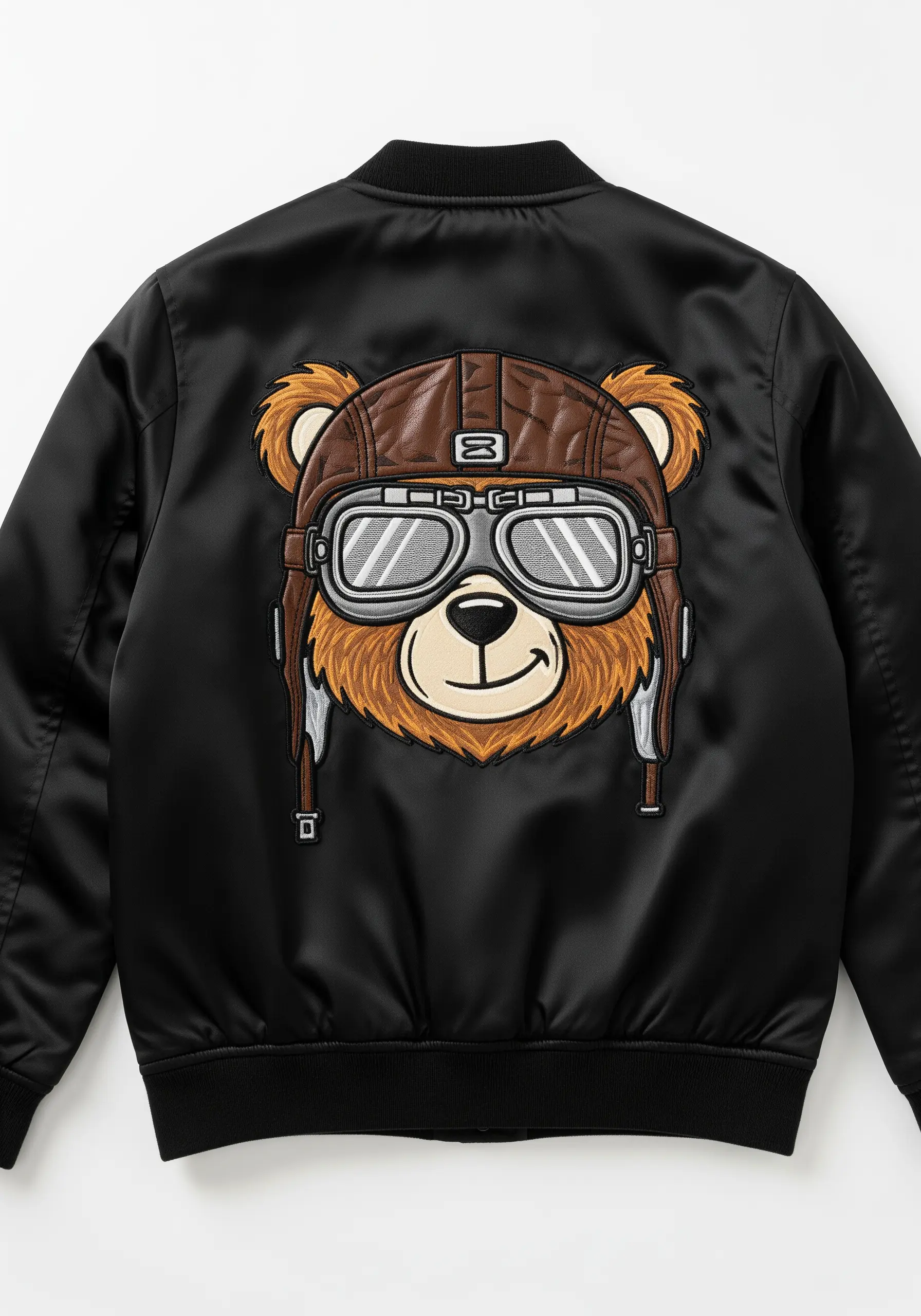 A cartoon bear wearing a vintage pilot helmet and goggles embroidered on a black satin bomber jacket