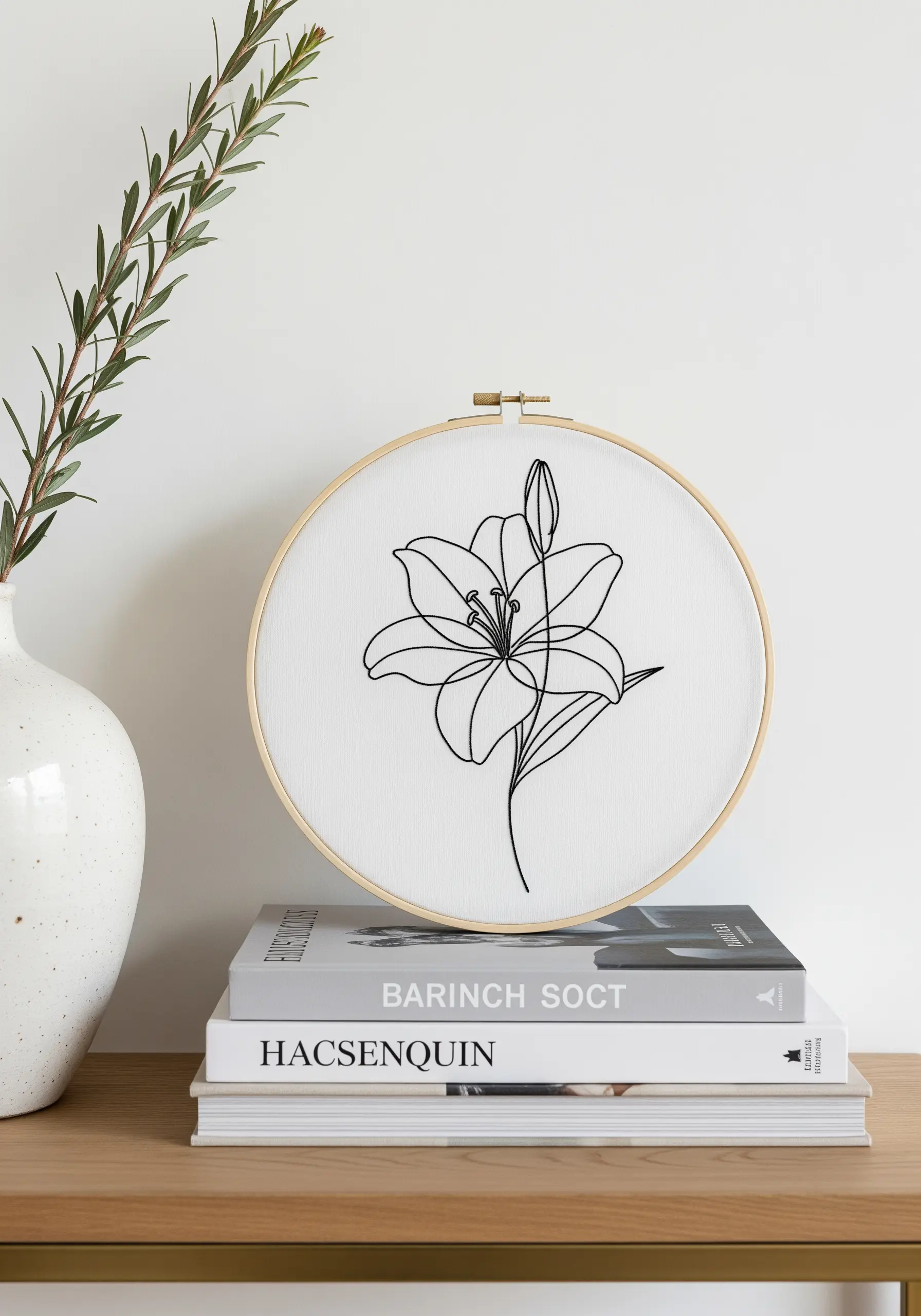 Minimalist single-line floral embroidery of a lily on white fabric