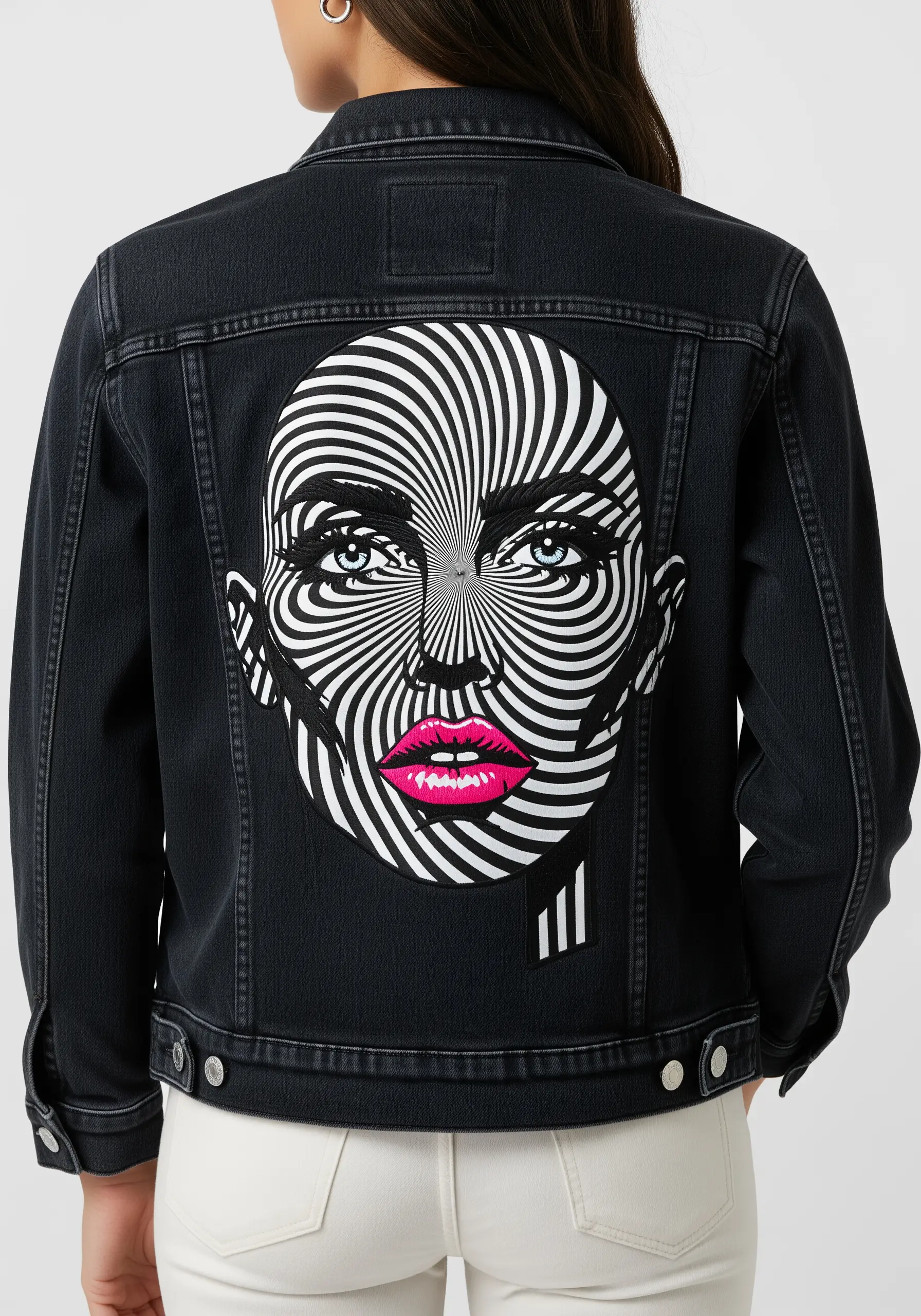 A large patch on a black denim jacket featuring a face with a black-and-white optical illusion pattern.