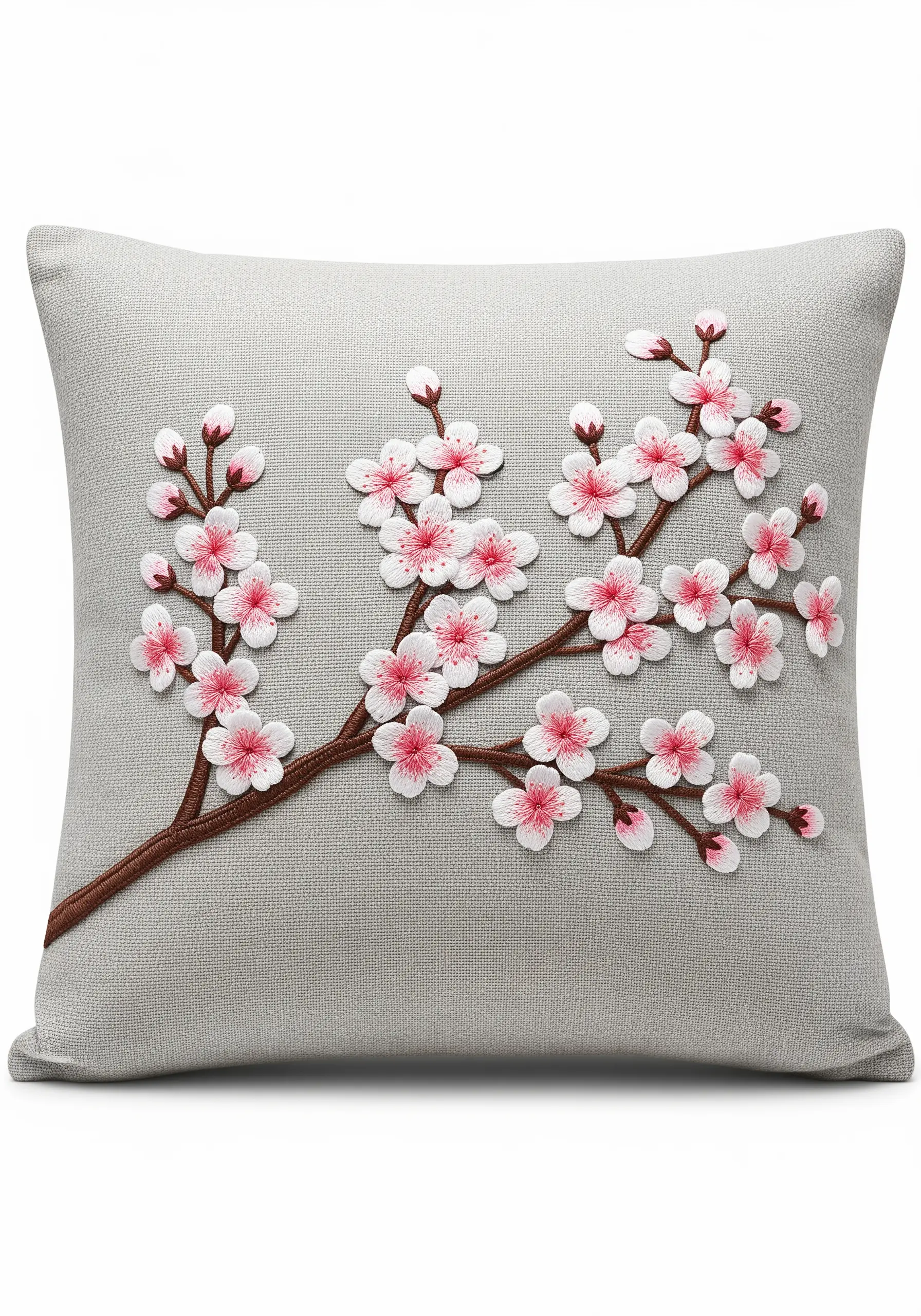 A branch of dimensional cherry blossoms with pink centers stitched on a grey cushion cover.
