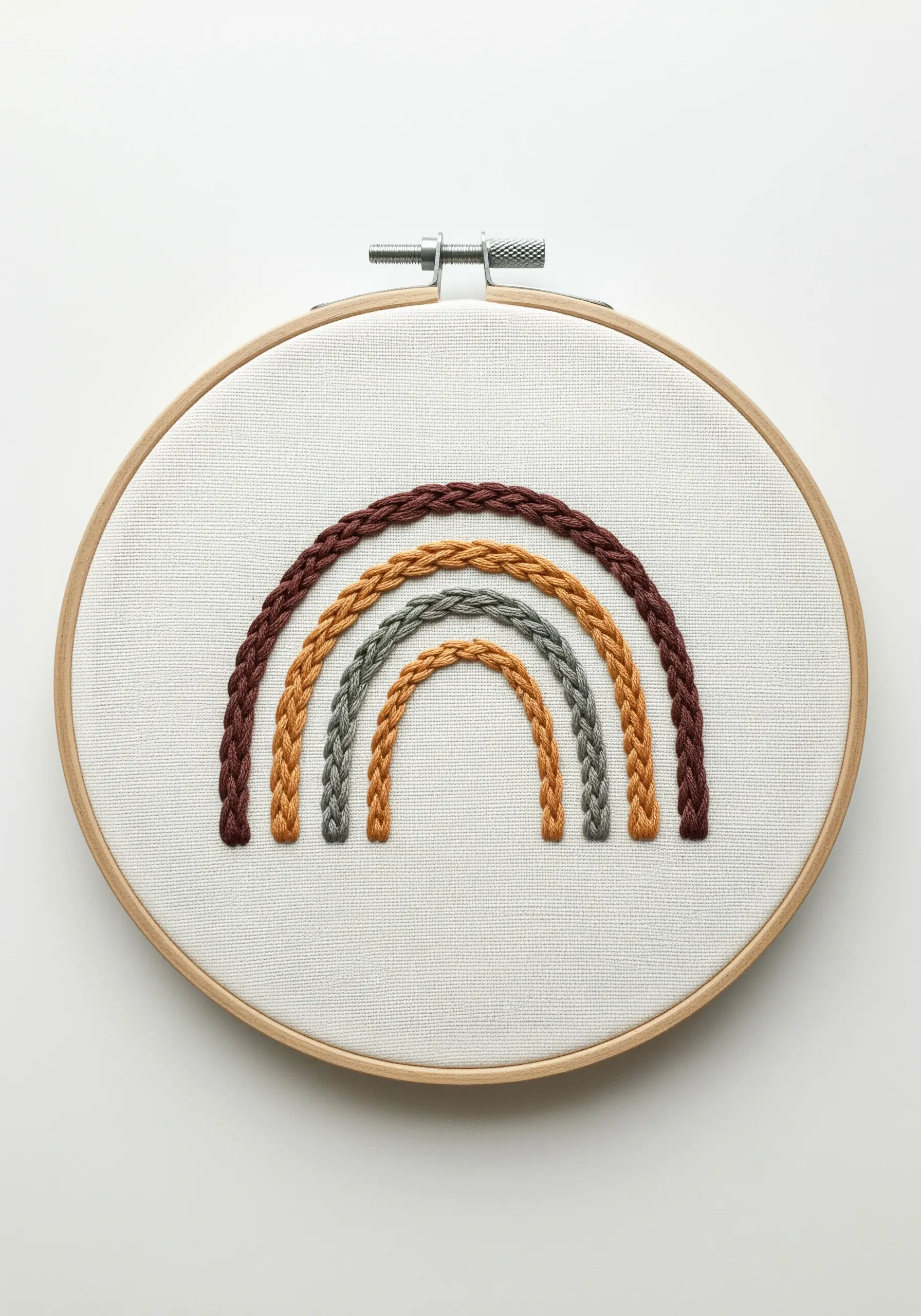 A modern rainbow embroidered with a heavy chain stitch in earthy, muted colors.