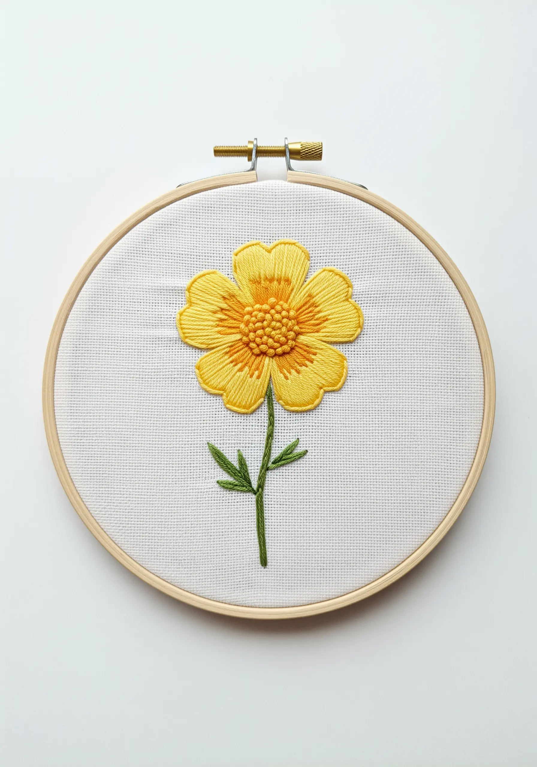 A vibrant yellow flower with a textured French knot center and smooth satin stitch petals.