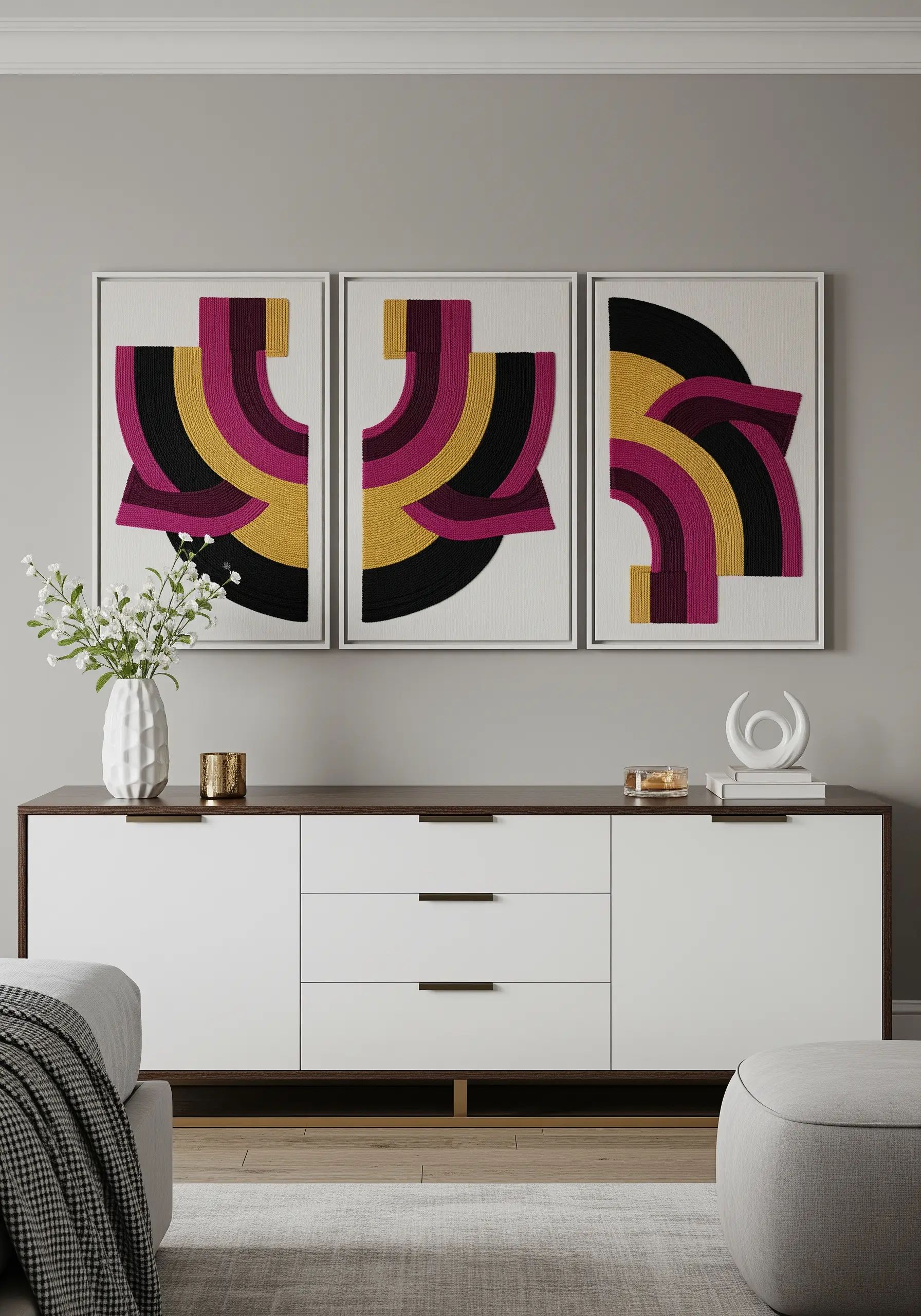 A set of three framed embroidery pieces creating a single abstract geometric design.