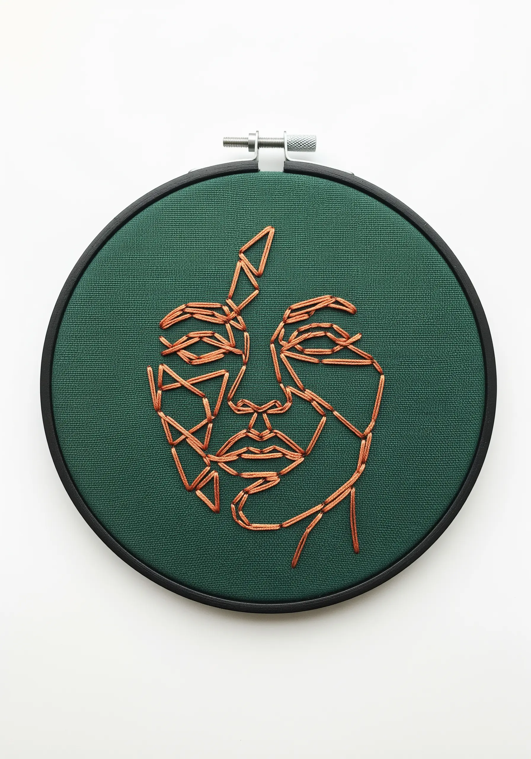 A face profile constructed from intersecting straight stitches in metallic copper thread on green fabric.