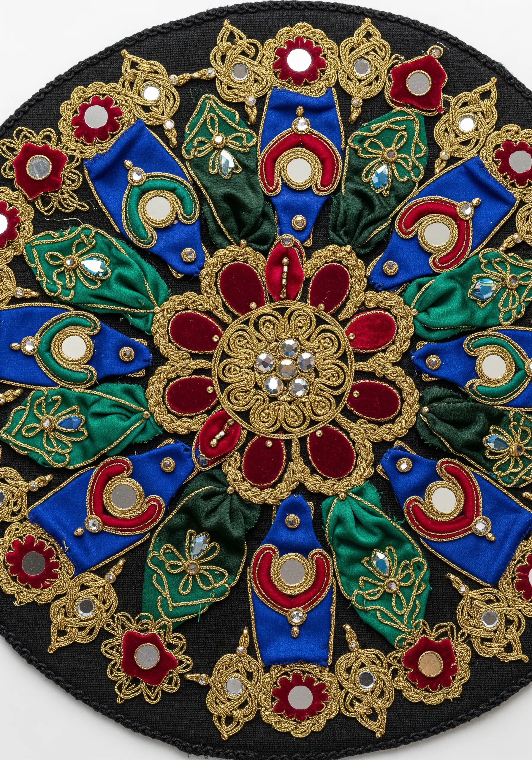 Ornate circular mandala with folded ribbon, couched gold cord, and mirrored embellishments.
