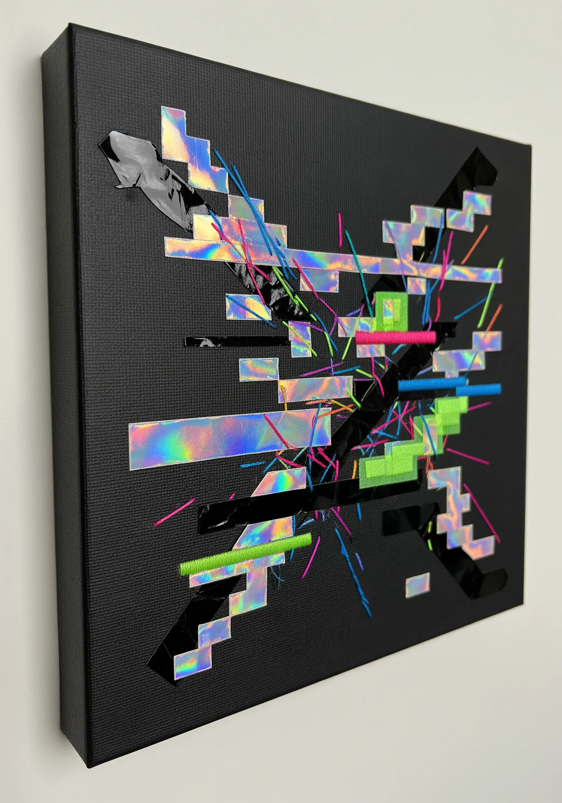 Glitch art on black canvas using holographic tape and chaotic neon thread stitches.