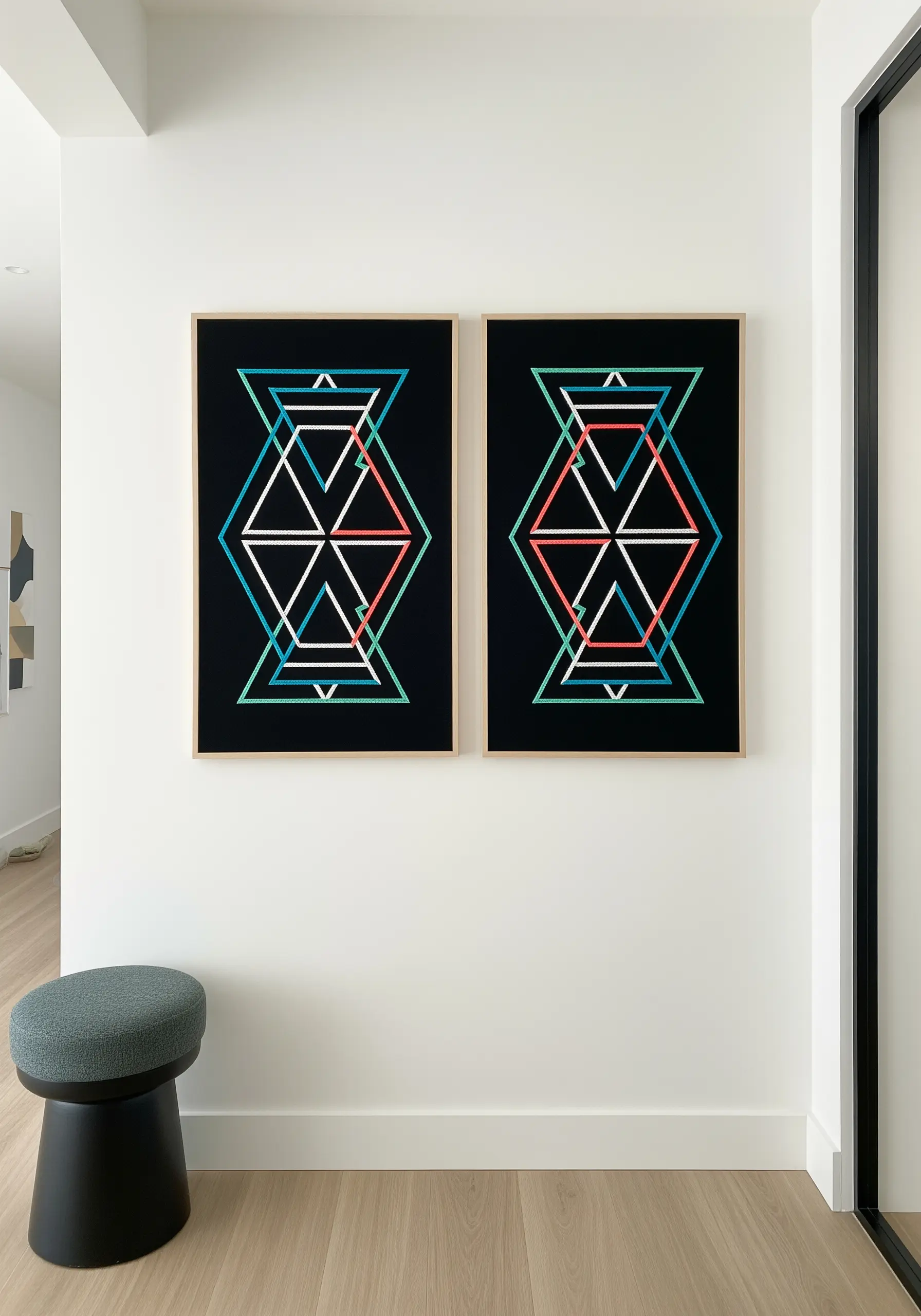 Two framed pieces of intersecting geometric line art in bright colors.