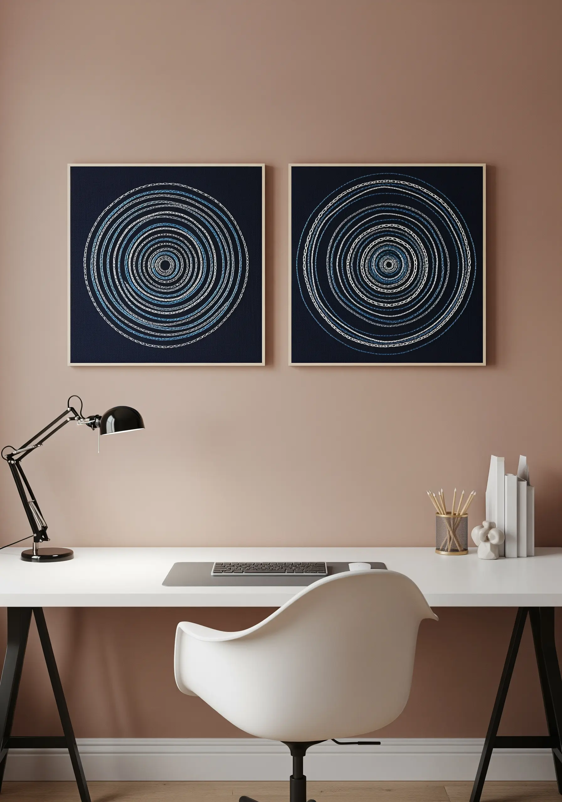 Two framed embroidery pieces on dark fabric featuring concentric circles in blue and white threads.