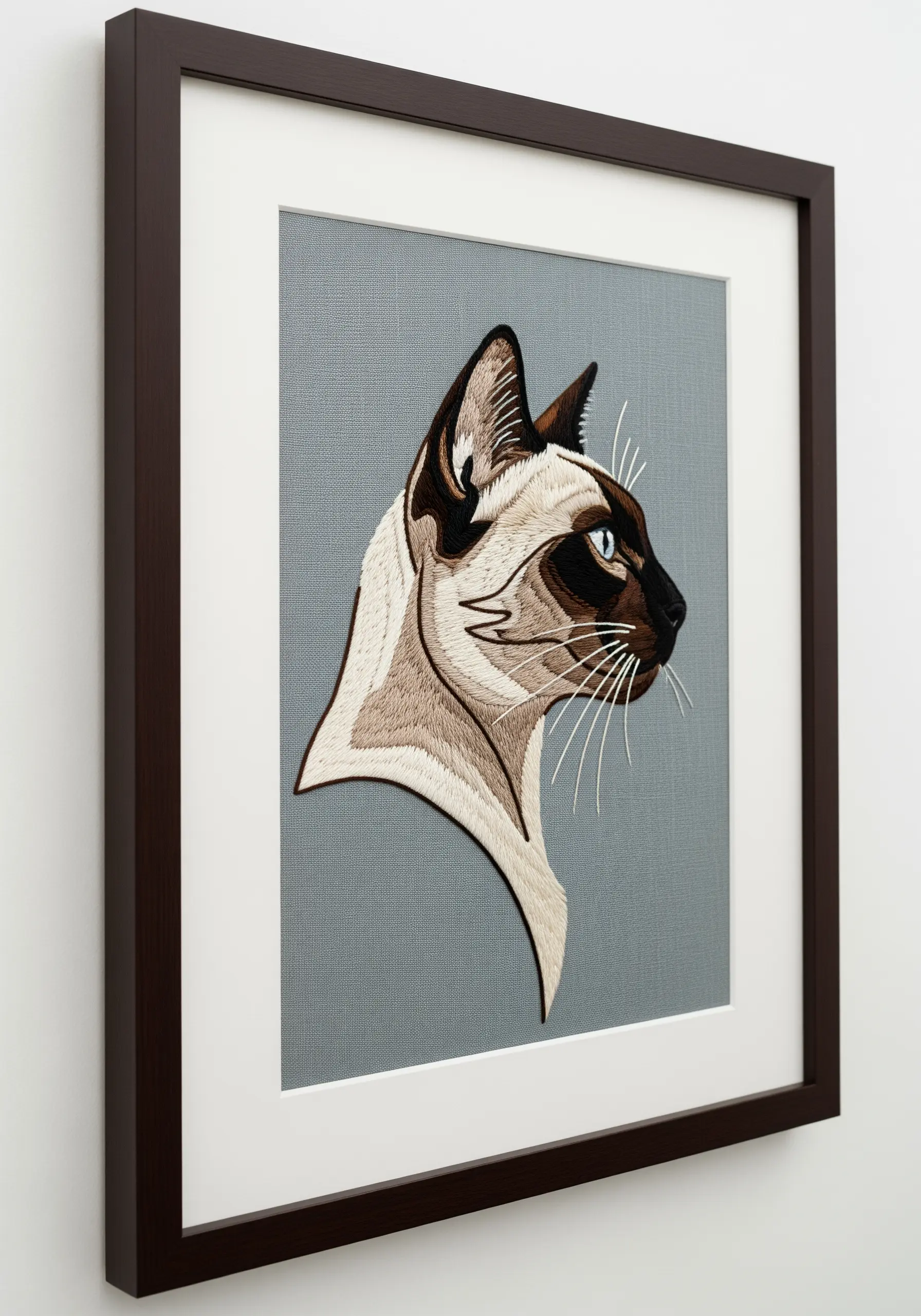 Realistic, detailed embroidery portrait of a Siamese cat, framed and matted.
