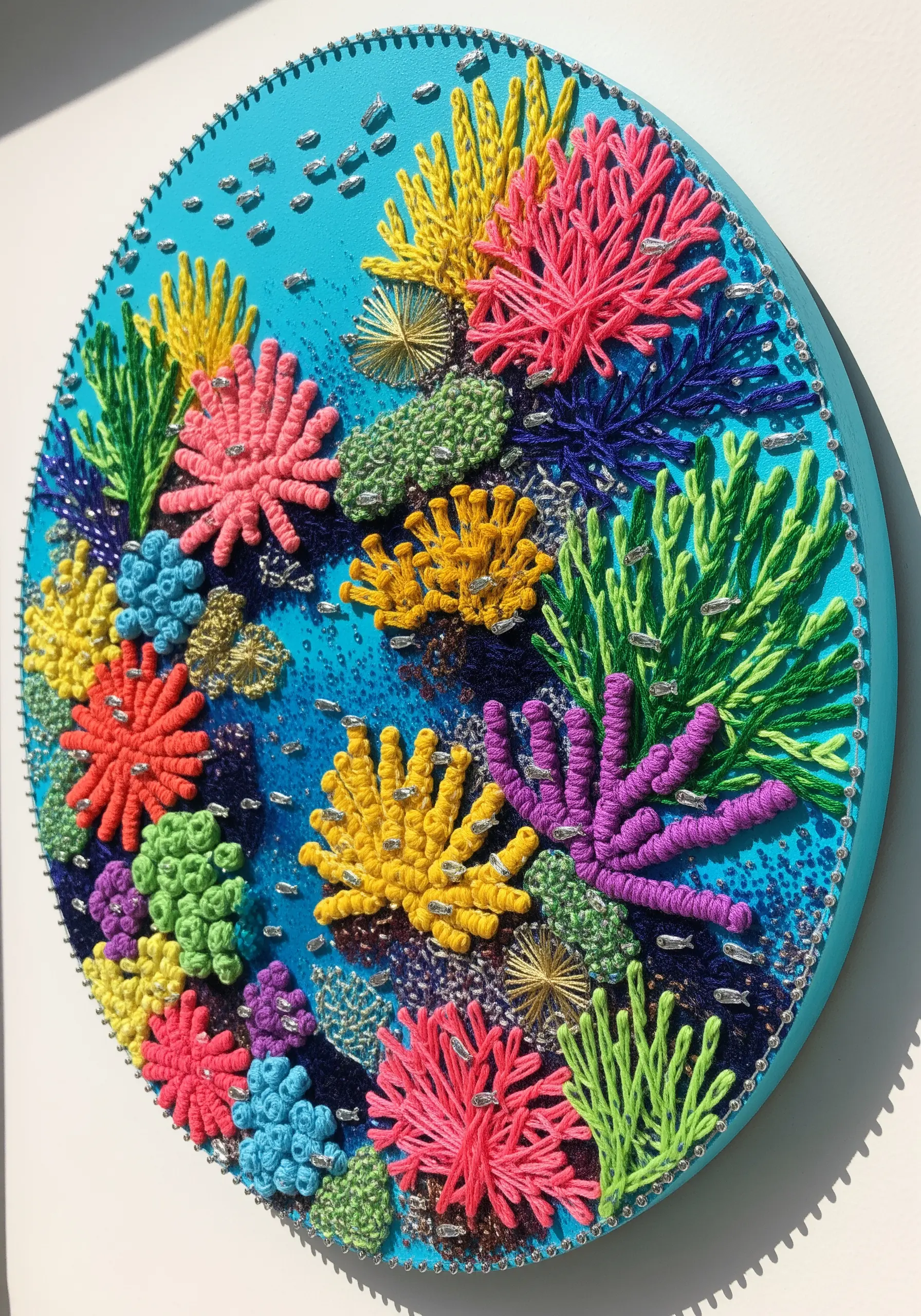 A vibrant, high-texture string art piece depicting a colorful coral reef on a blue background.