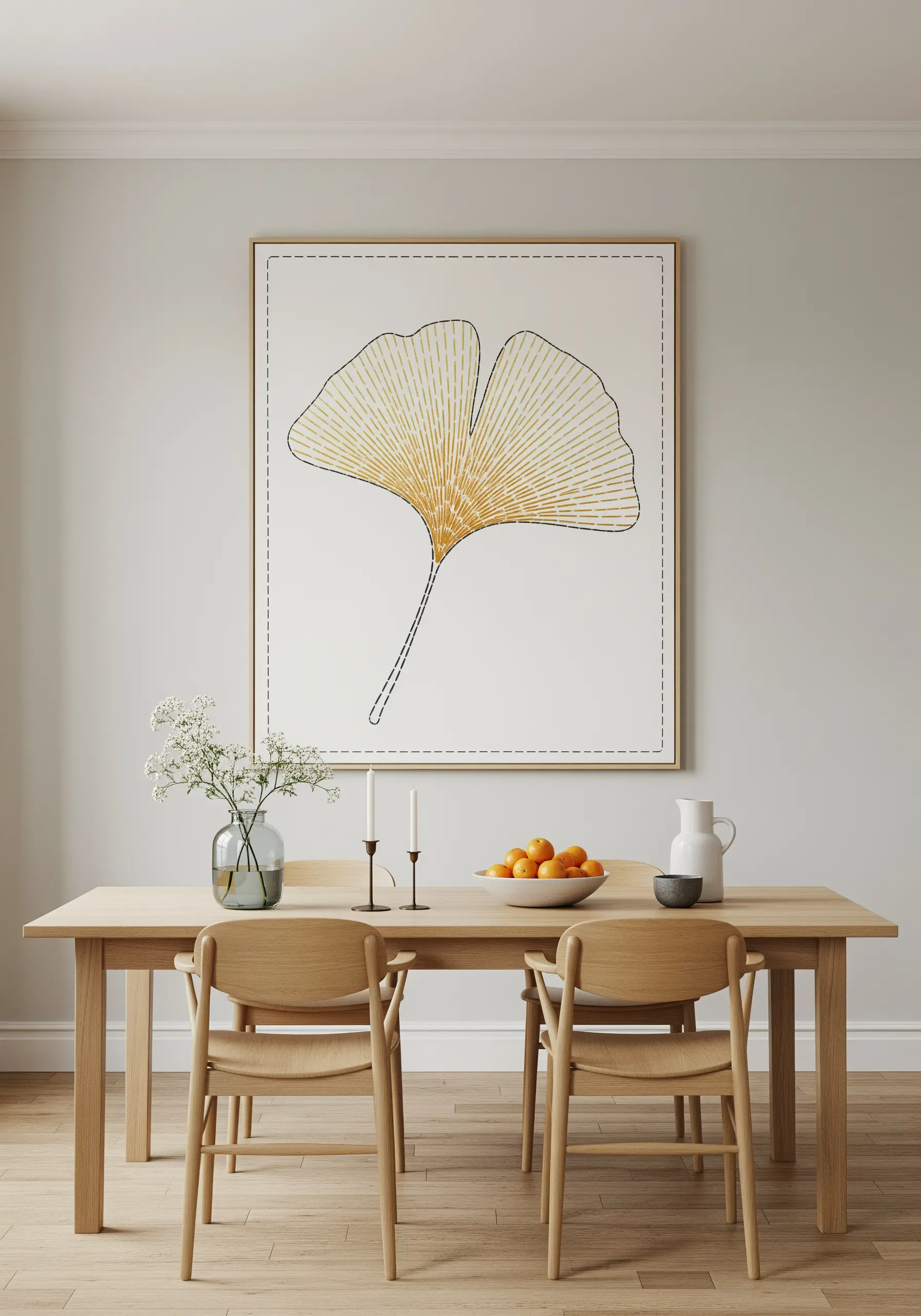 Minimalist framed embroidery of a ginkgo leaf using radiating gold stitches on white canvas.
