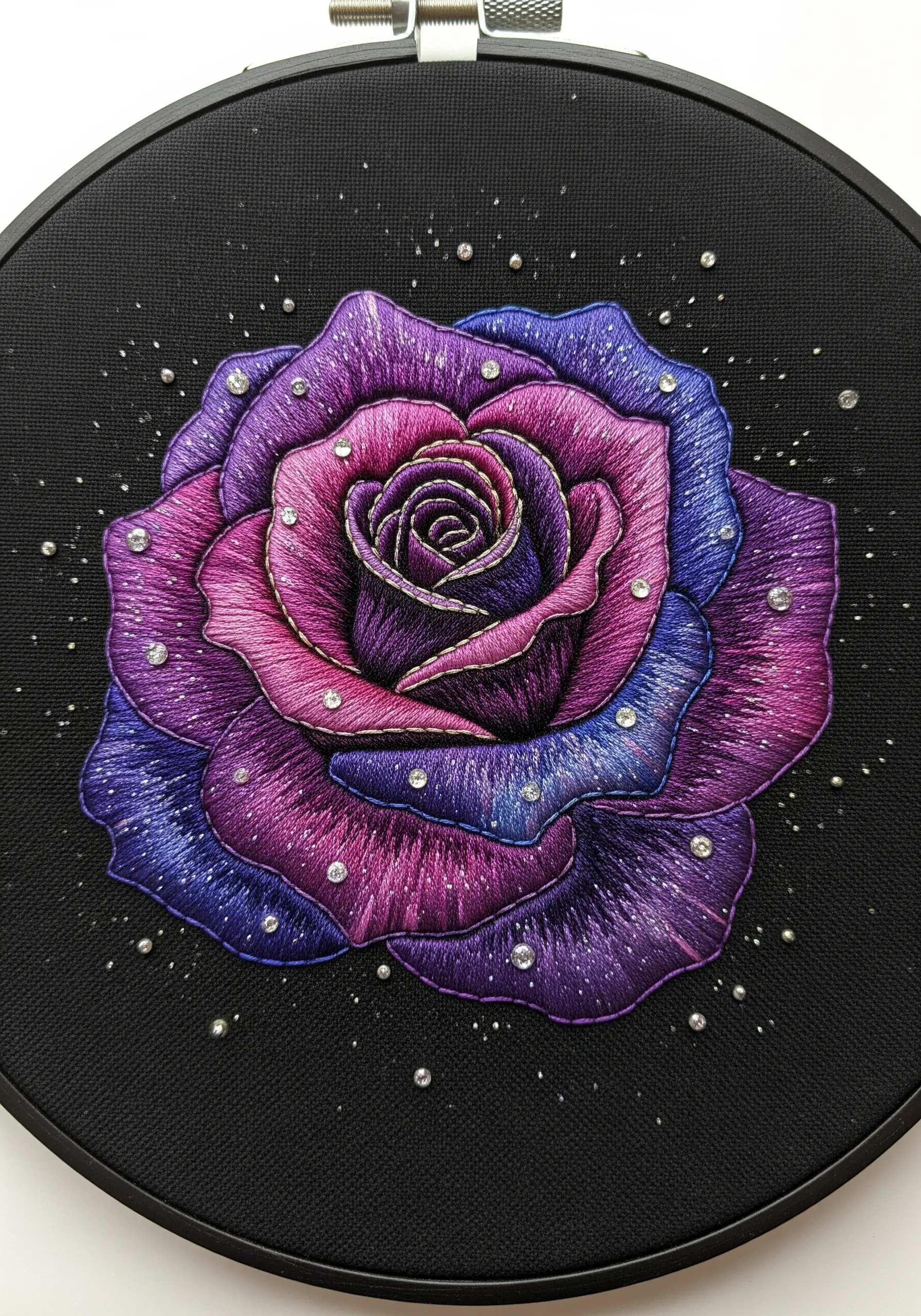 A rose embroidered with a purple and blue galaxy gradient, embellished with tiny rhinestones.