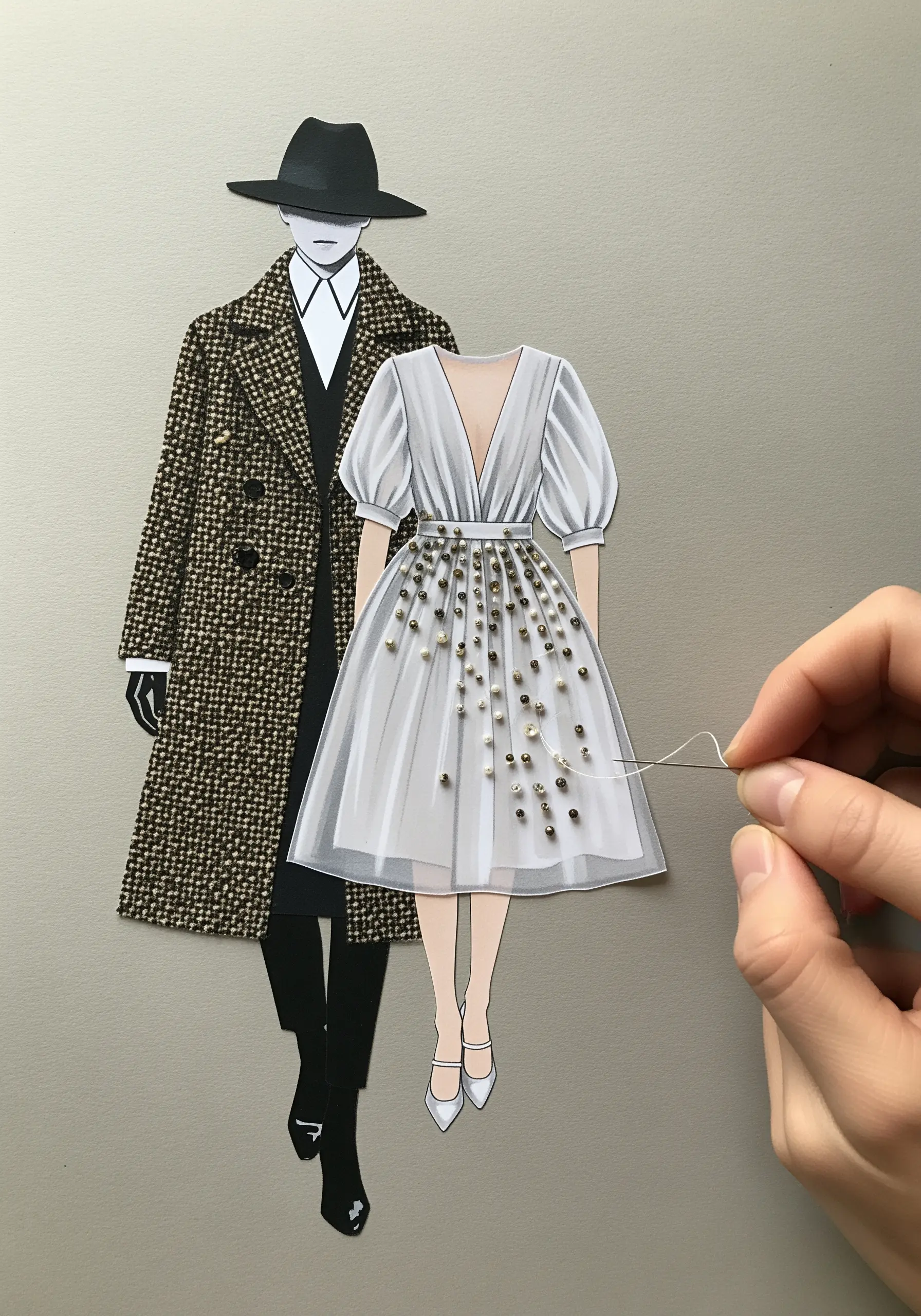 A paper fashion illustration of a dress embellished with scattered gold and silver beads.