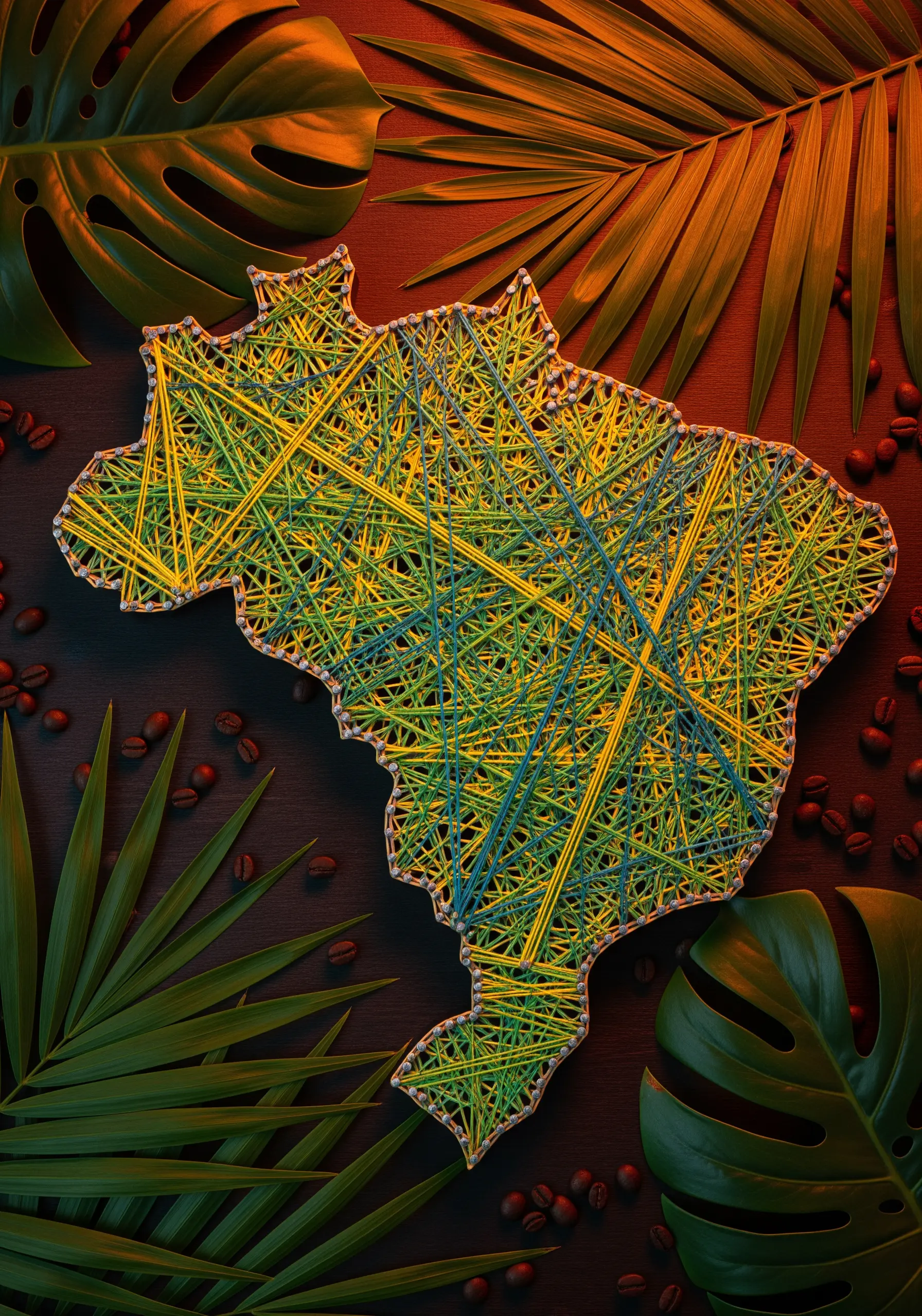 String art map of Brazil filled with chaotic layers of vibrant green, yellow, and blue thread.