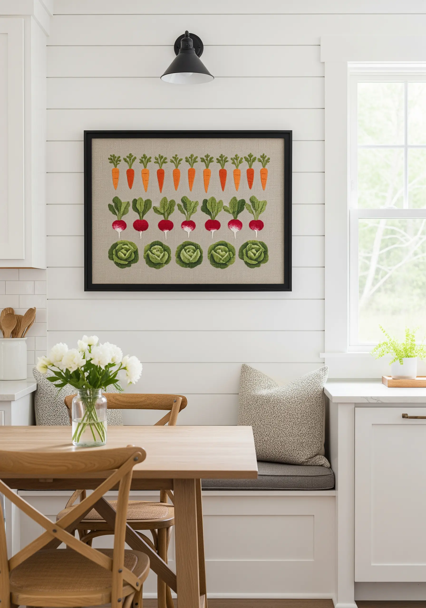 Framed embroidery of neatly arranged rows of carrots, radishes, and lettuce.