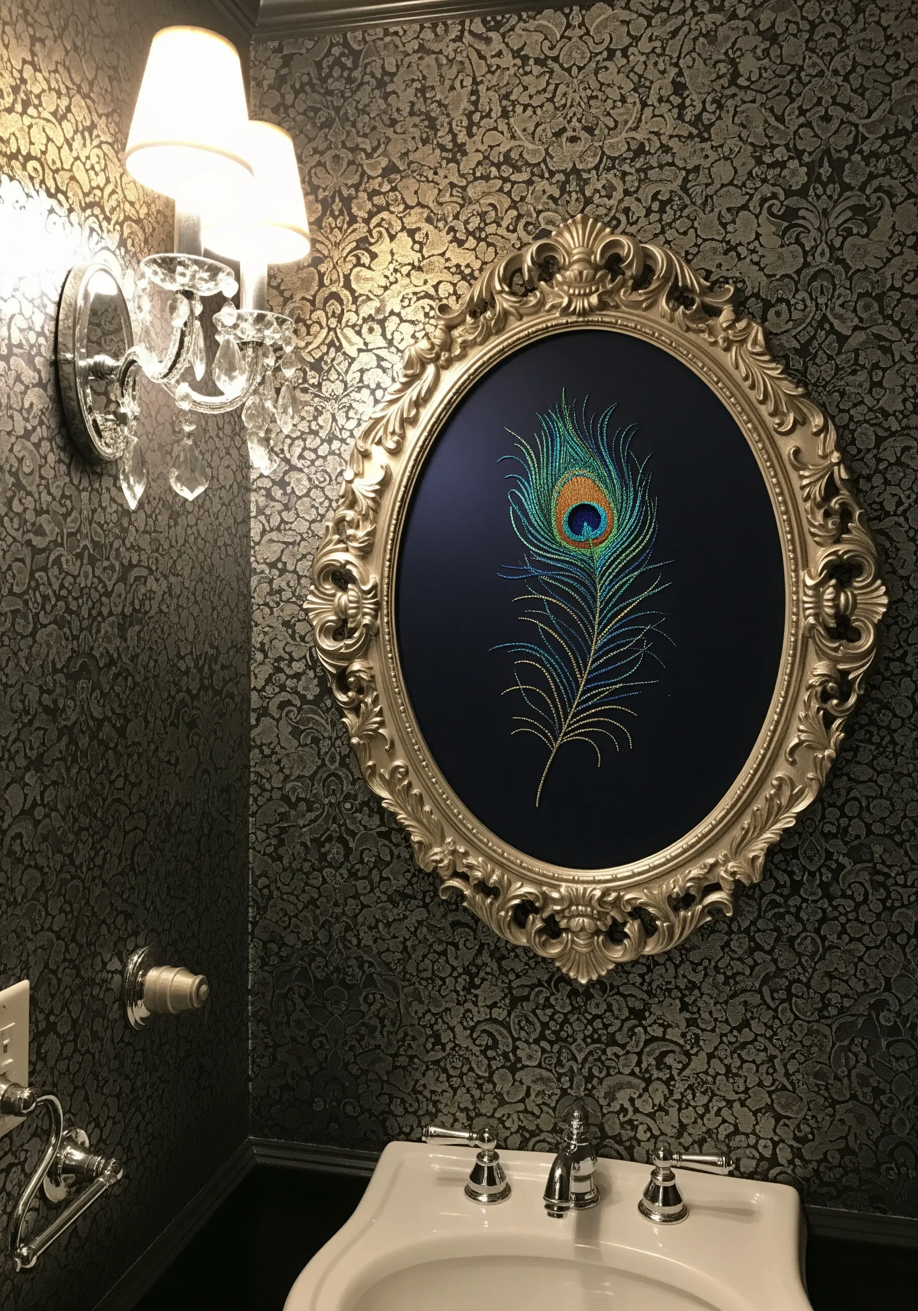 A single embroidered peacock feather in a large, ornate silver oval frame.