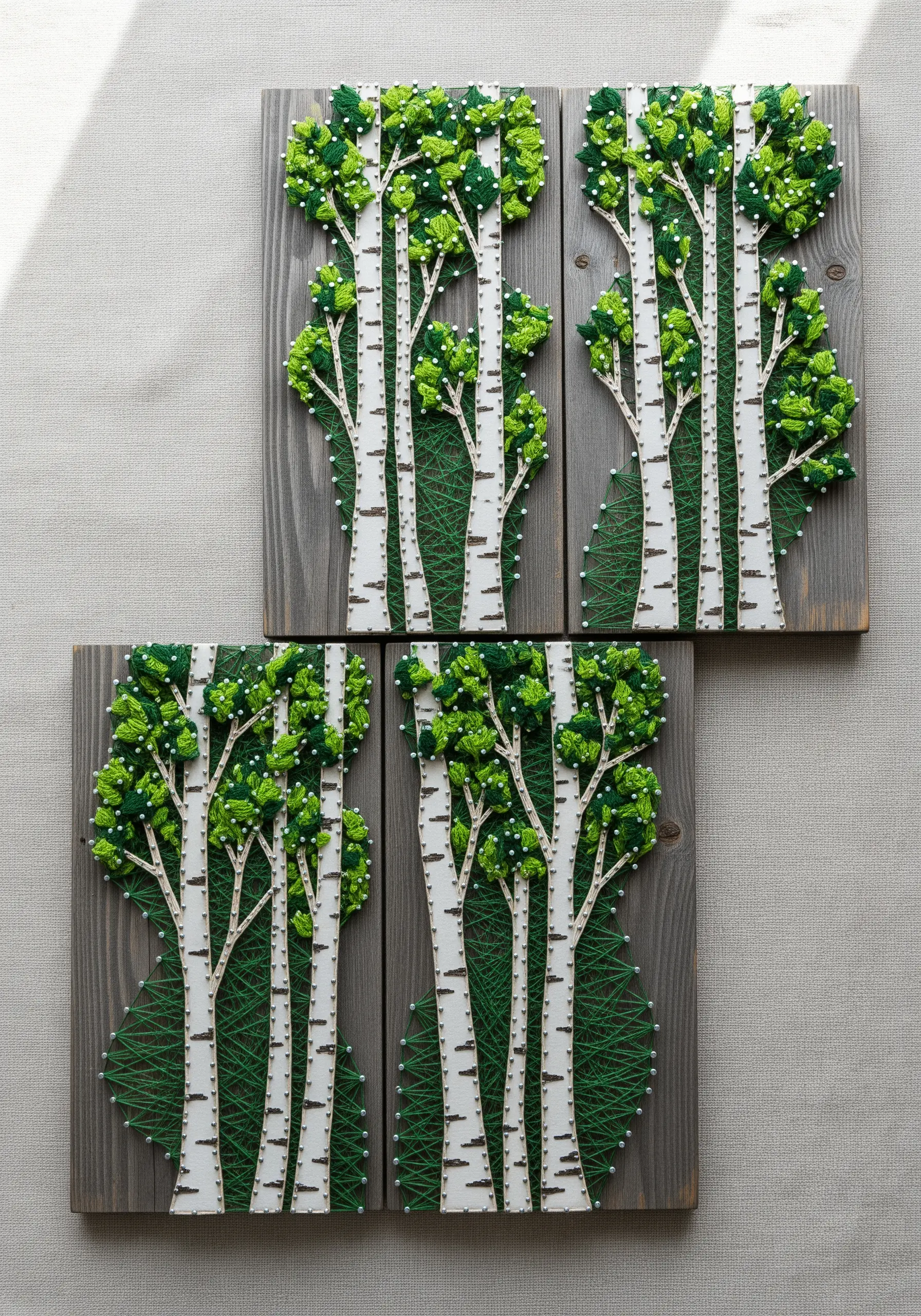 String art of birch trees with textured green leaves made from dense knots.
