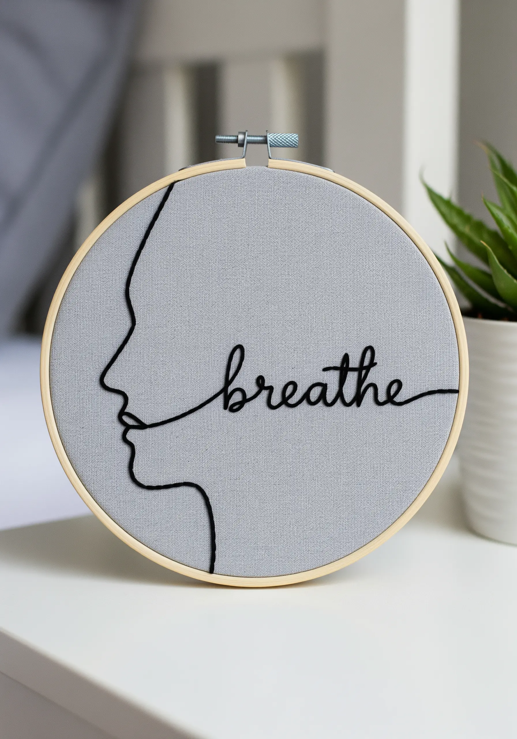 A black line art profile from which the cursive word 'breathe' flows continuously.