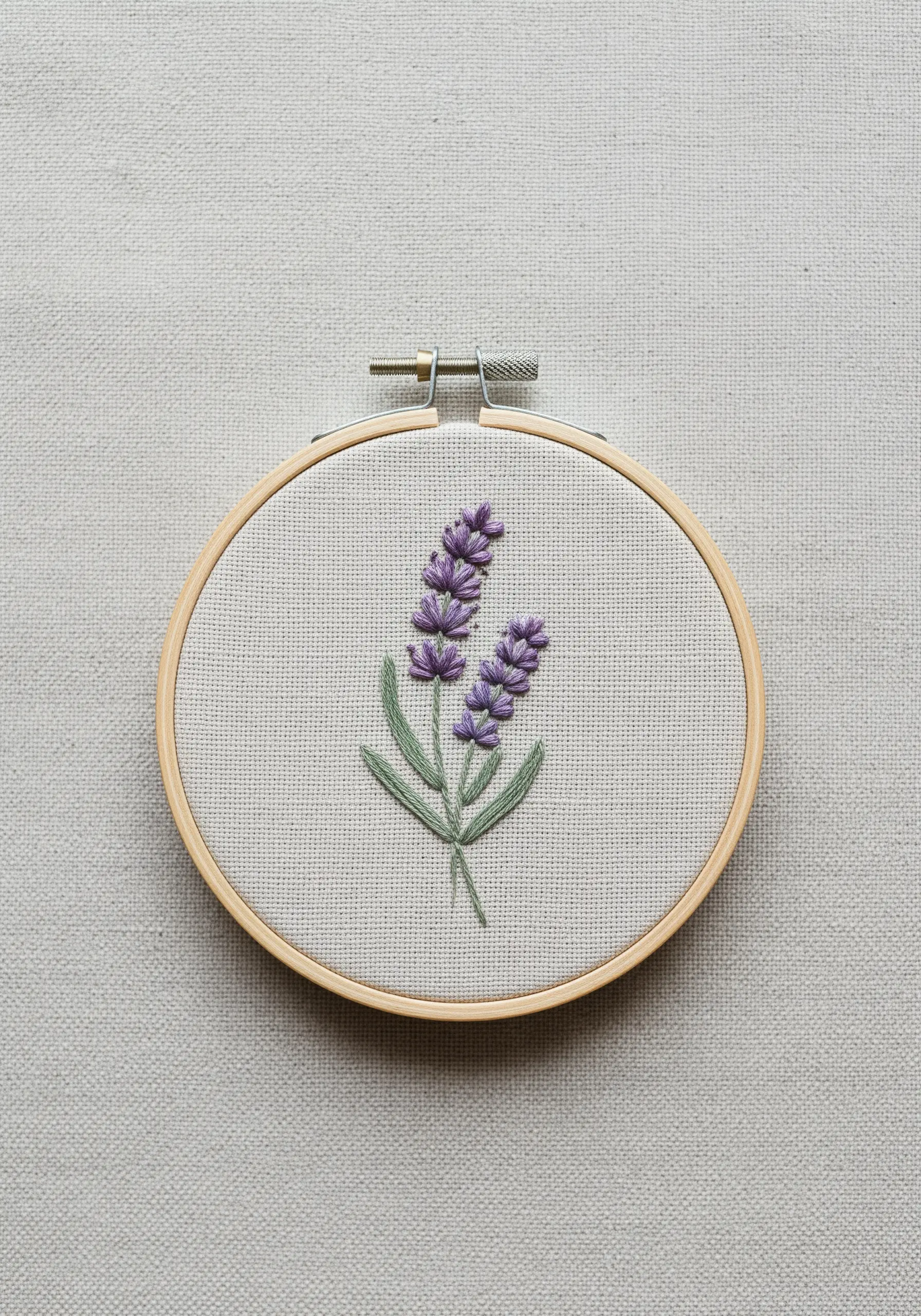 Embroidered lavender sprig with purple French knots and green stems.