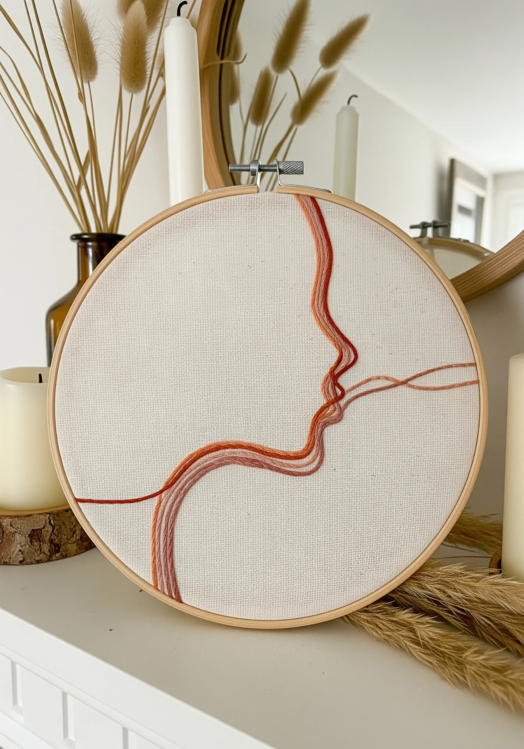 A profile stitched with multiple strands of rust and pink thread that flow loosely across the fabric.