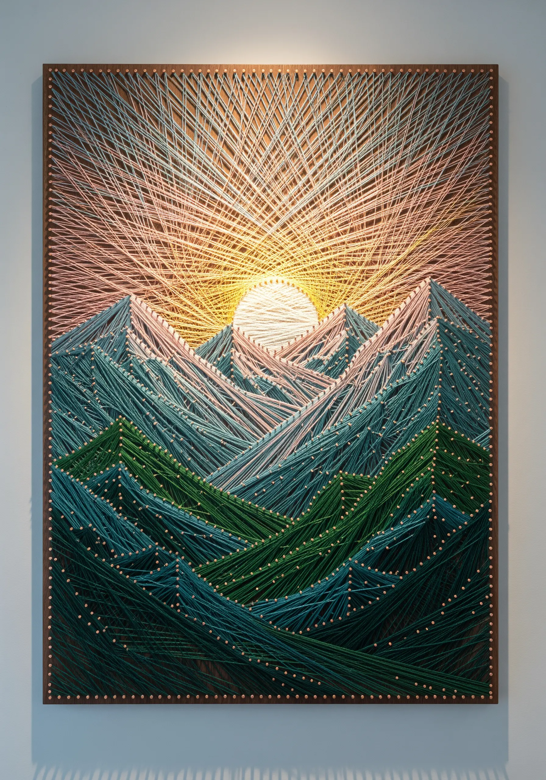 Mountain sunrise string art with a radiating sun and layered green and blue peaks.