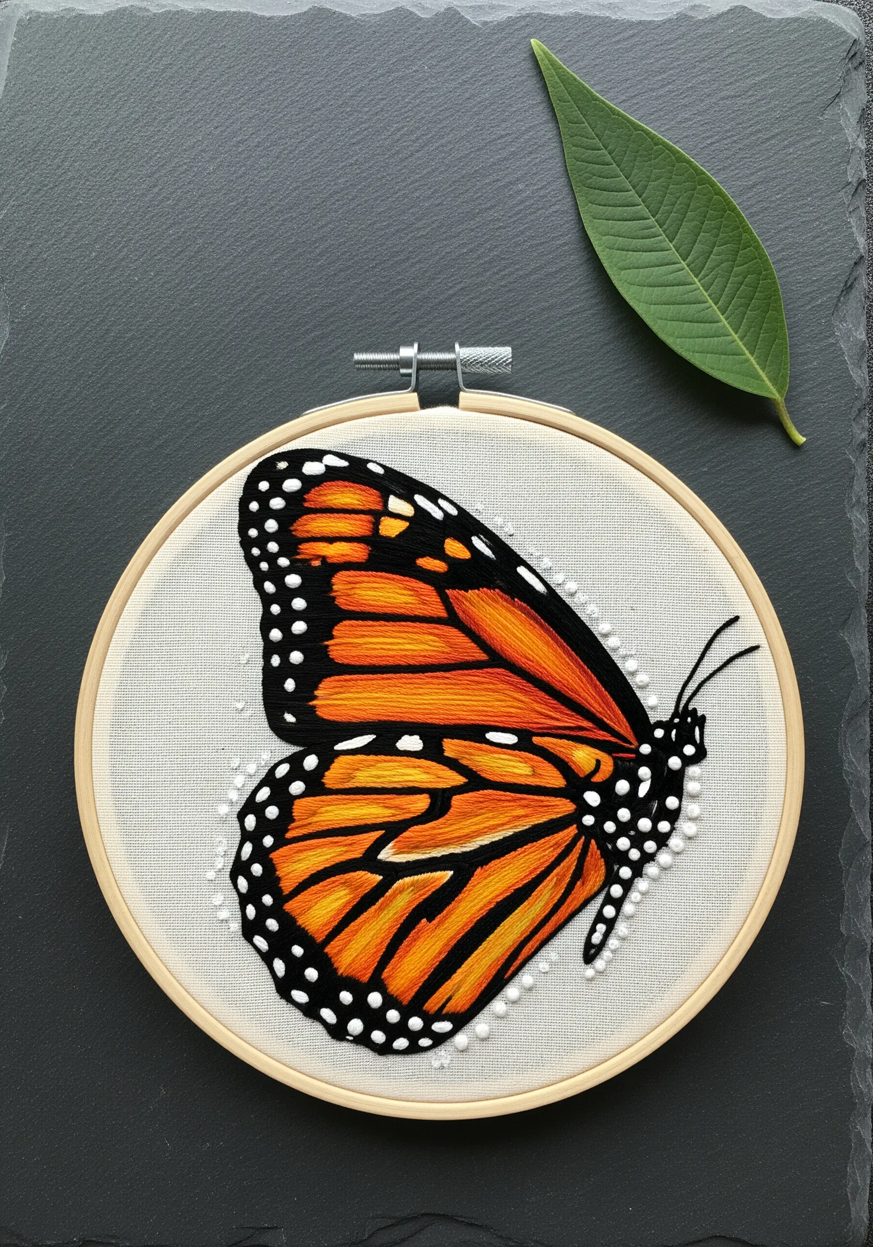 A realistic monarch butterfly wing embroidered using the long-and-short stitch for color blending.