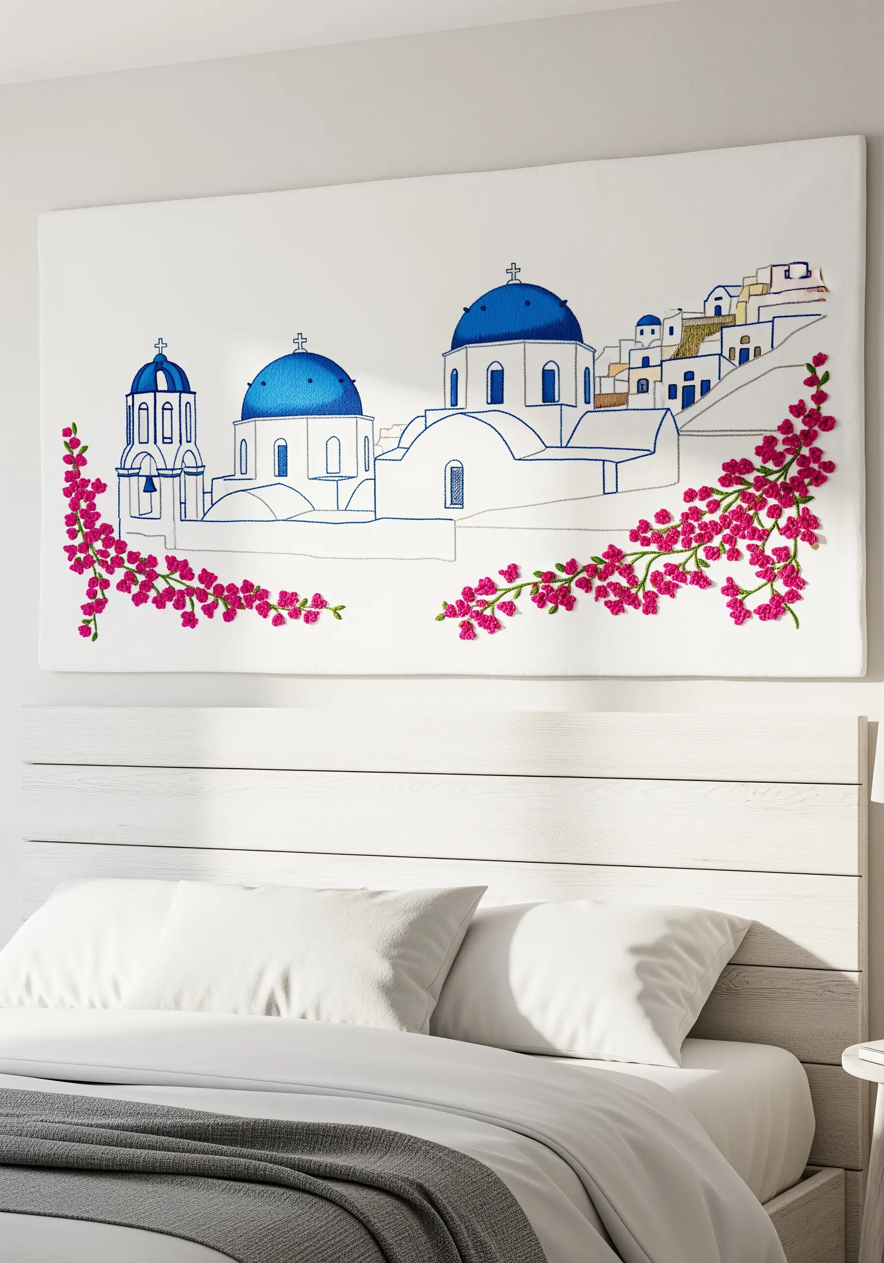Embroidered Santorini scene with blue line art buildings and 3D pink floral stitches.