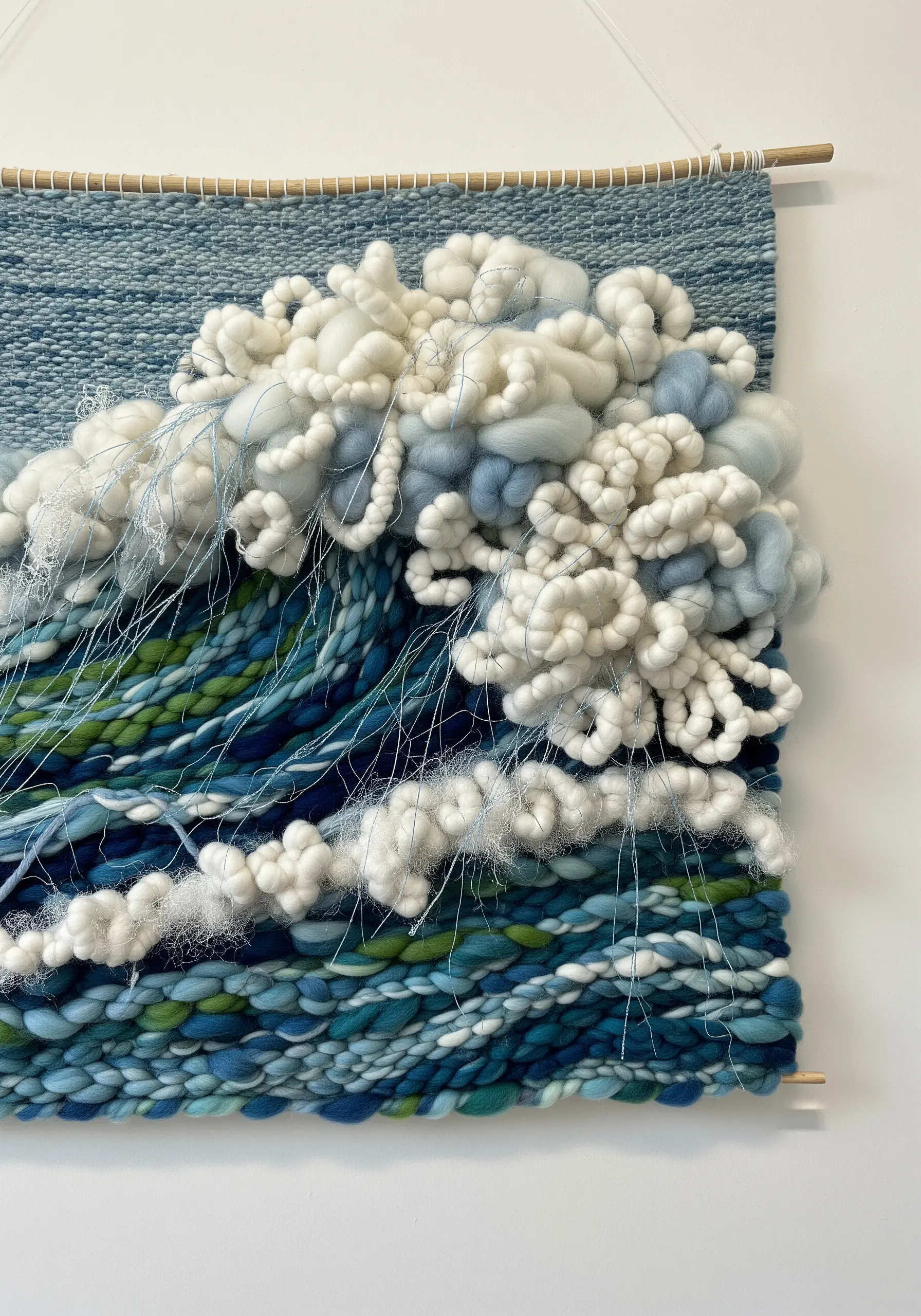 Woven wall hanging of an ocean wave with highly textured white roving for the sea foam.
