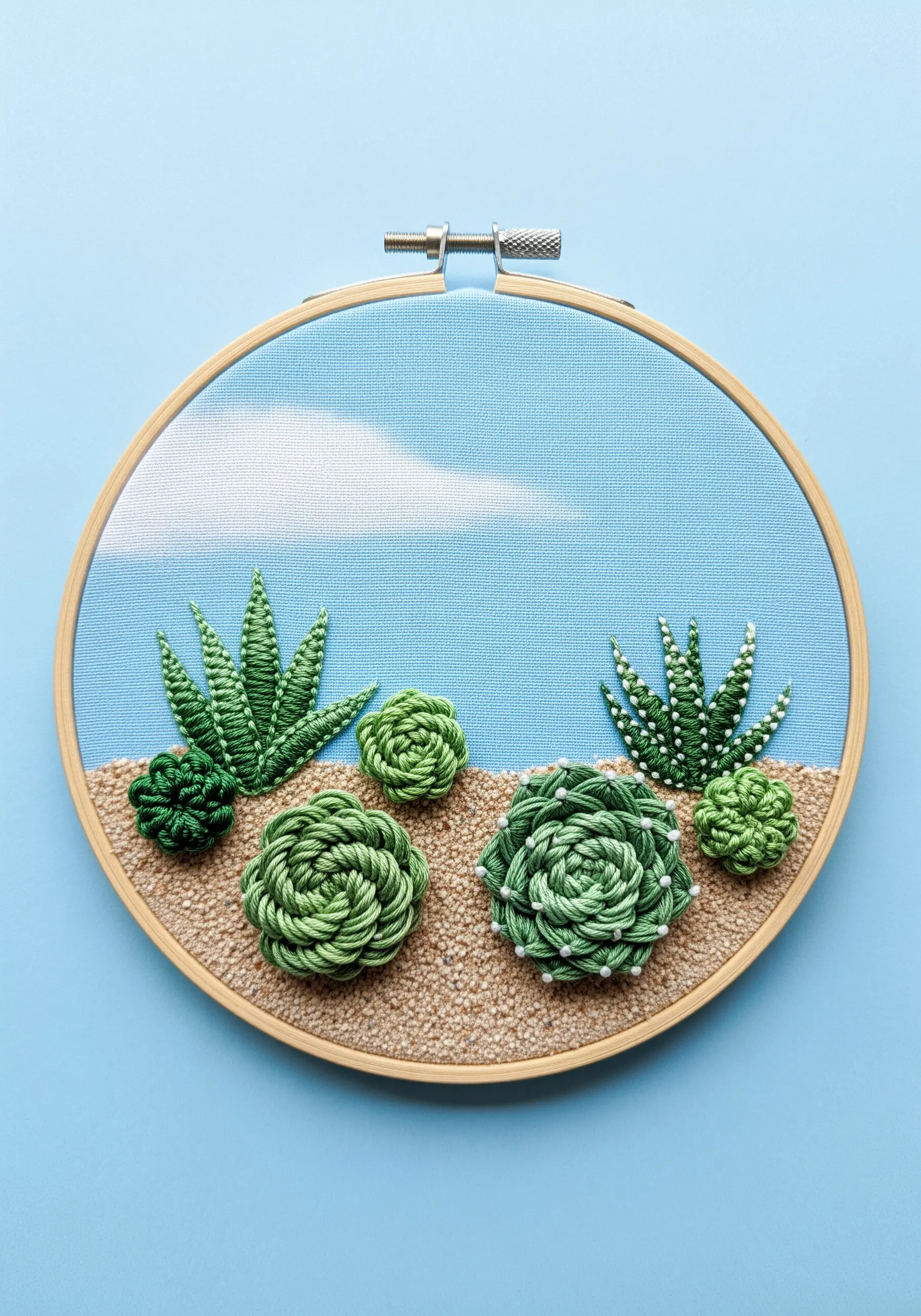 A dimensional embroidered succulent garden in a hoop using woven wheel stitches and beads