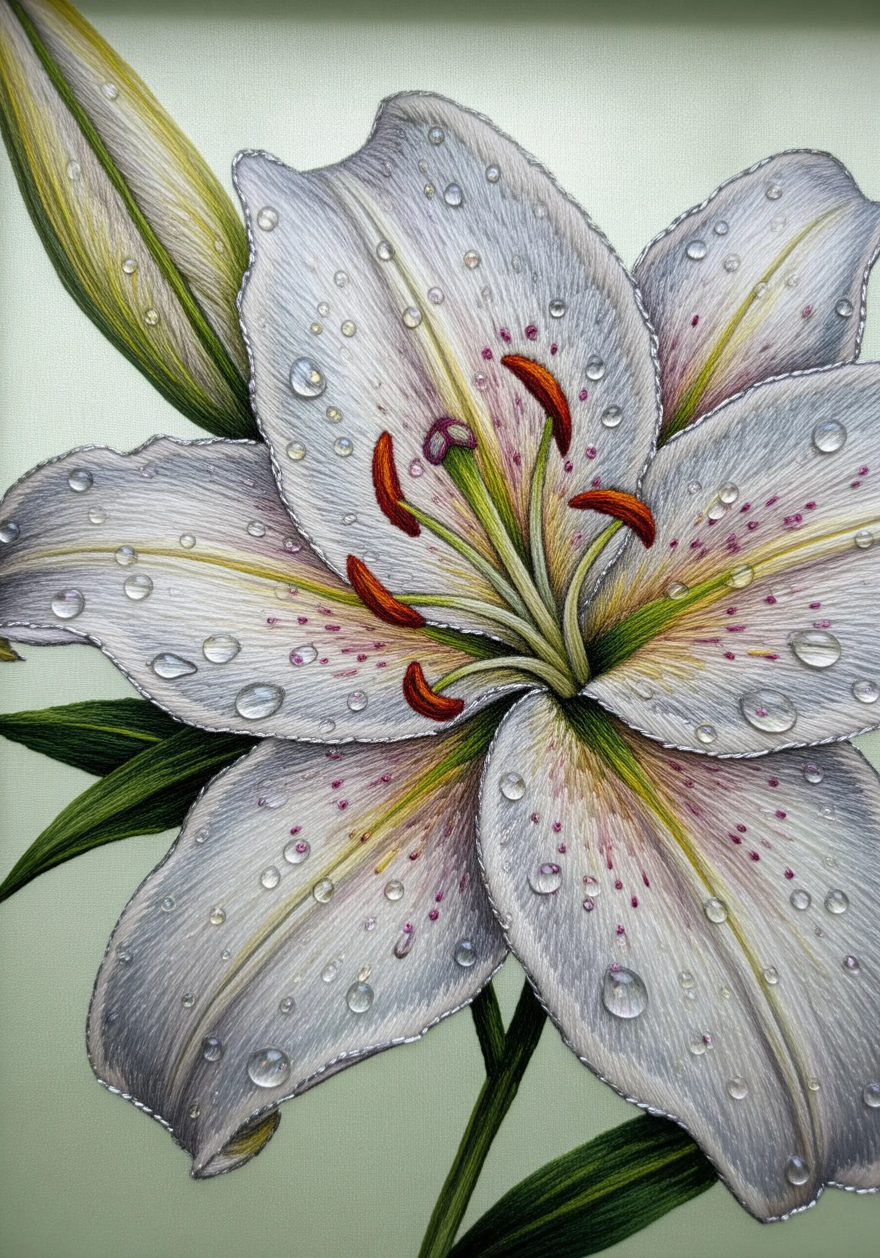 A white lily embroidered with subtle gray and pink shading and beaded water droplets.