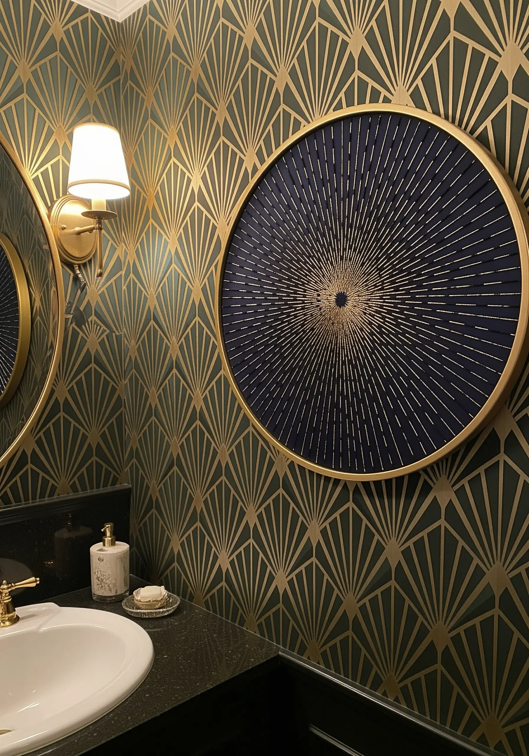 A large, round abstract embroidery of a sunburst in gold thread on navy fabric.