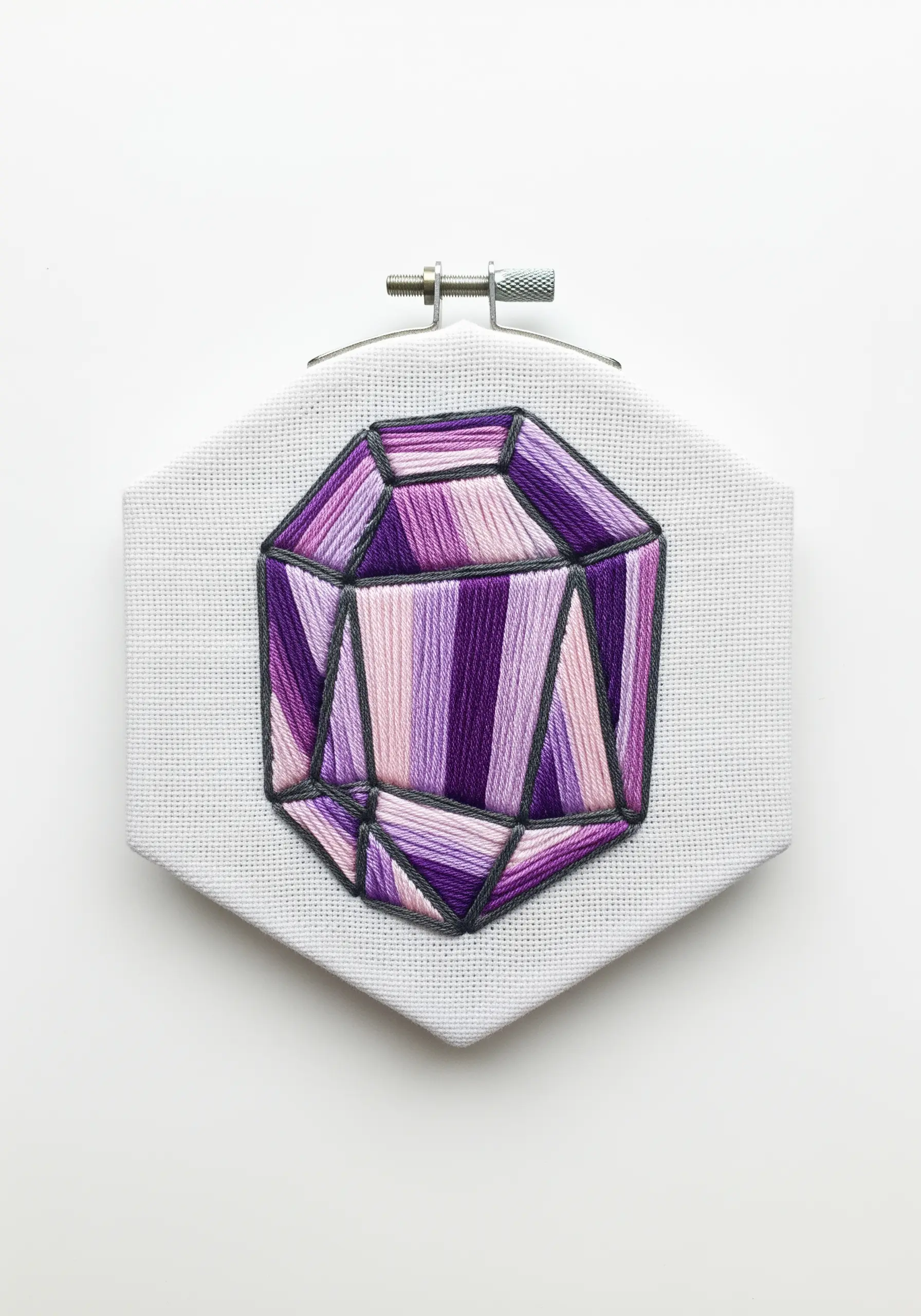 Embroidered amethyst gemstone with geometric facets in shades of purple satin stitch.