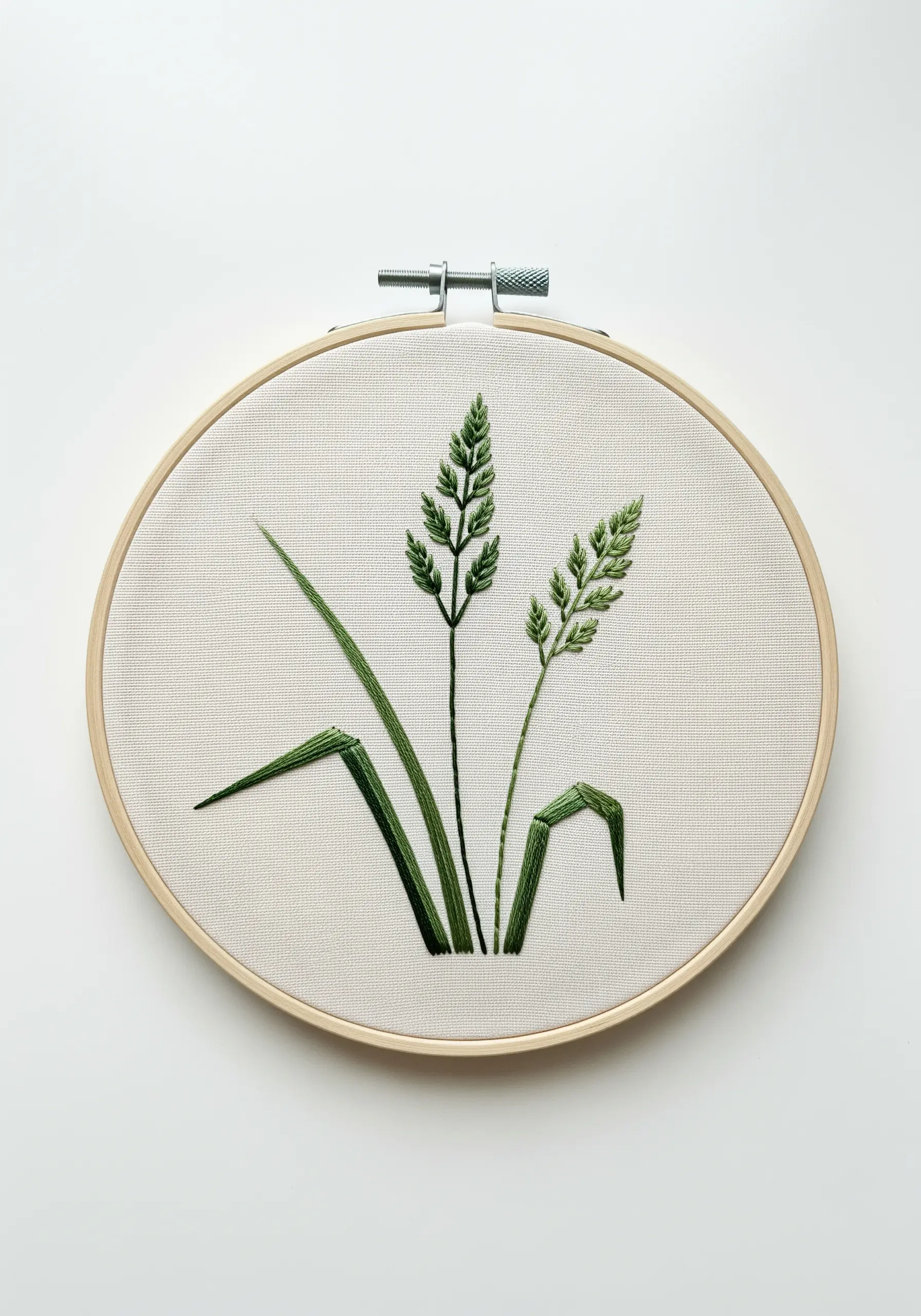 Two stalks of wild grass embroidered with fishbone stitch and satin stitch.