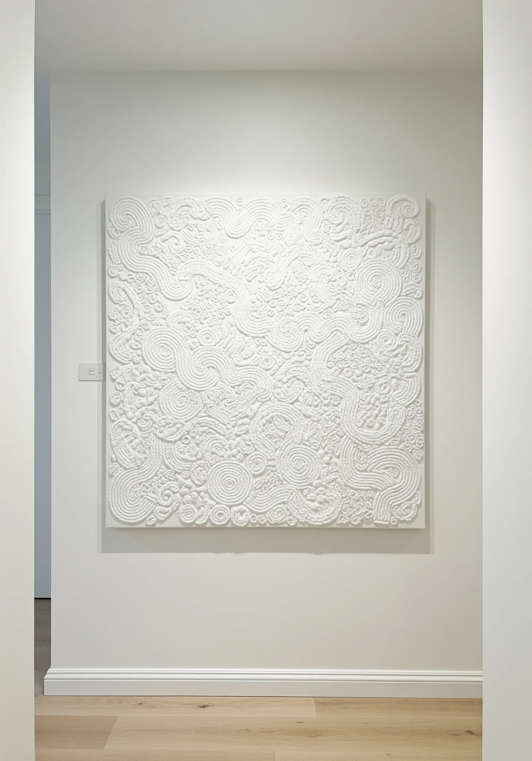 A large, all-white square canvas with dense, swirling embroidery textures.