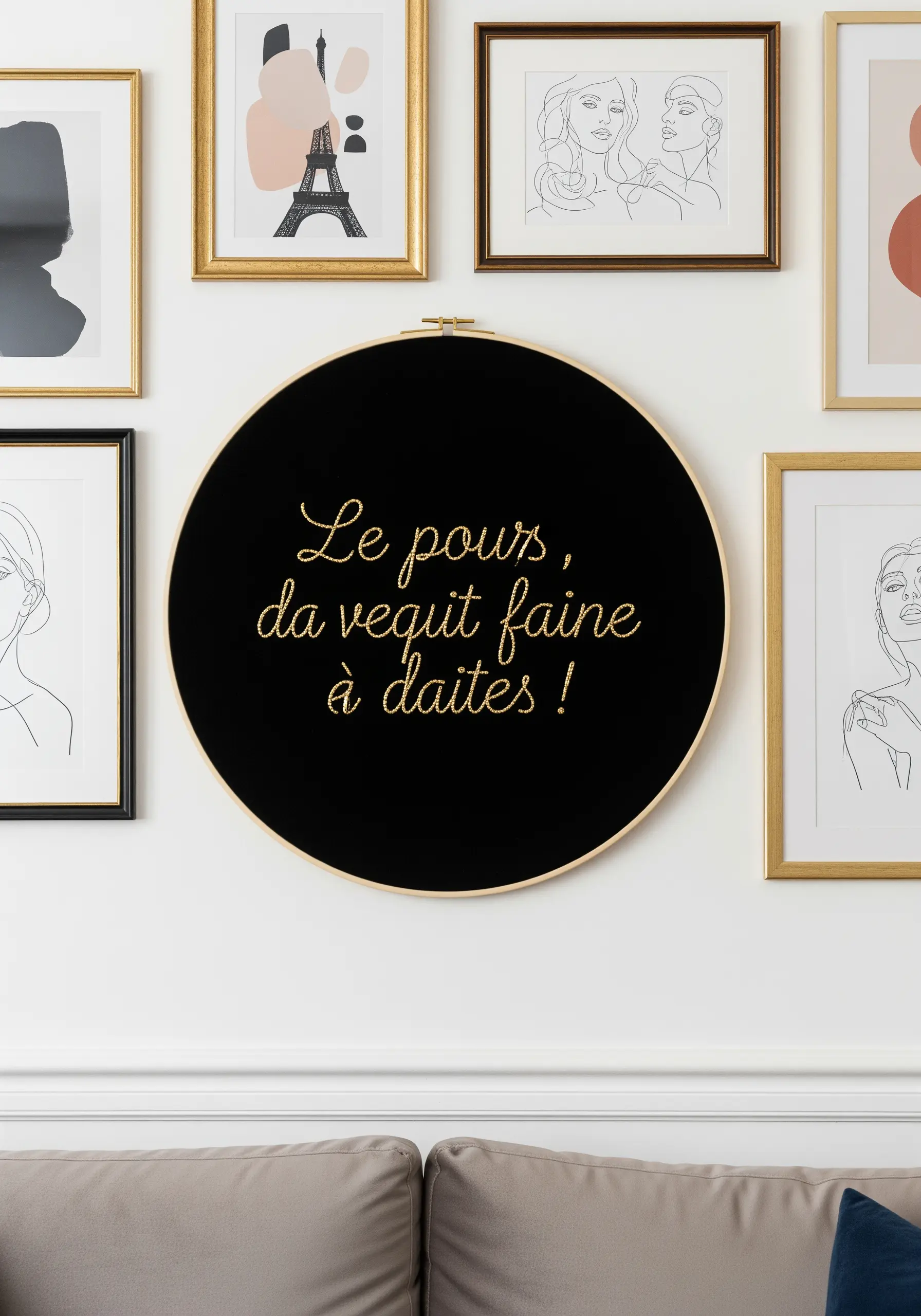 Gold metallic script embroidered on black velvet in a large hoop.
