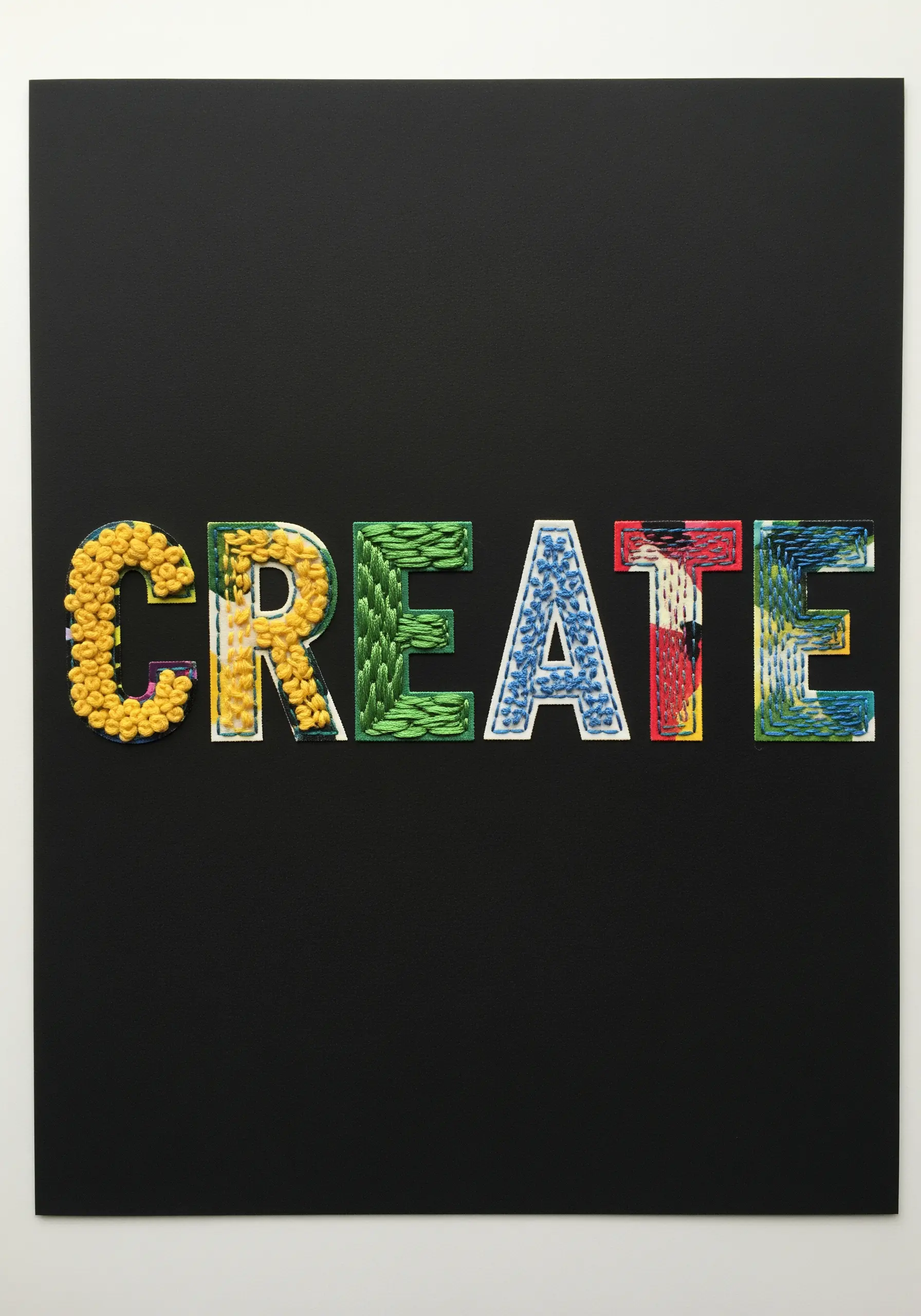 The word 'CREATE' with each letter filled with a different colorful embroidery stitch.