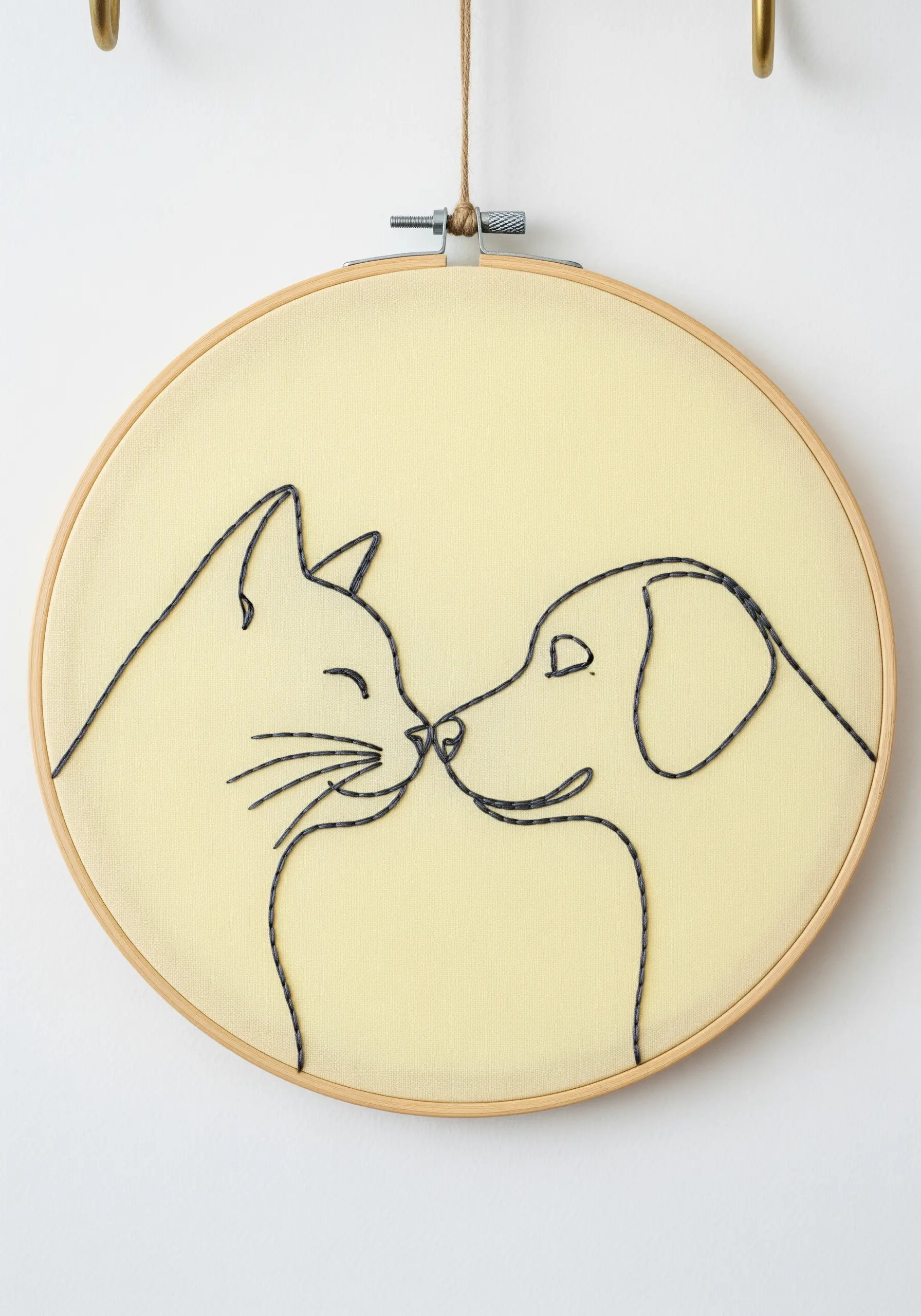 Continuous line art embroidery of a cat and dog touching noses.