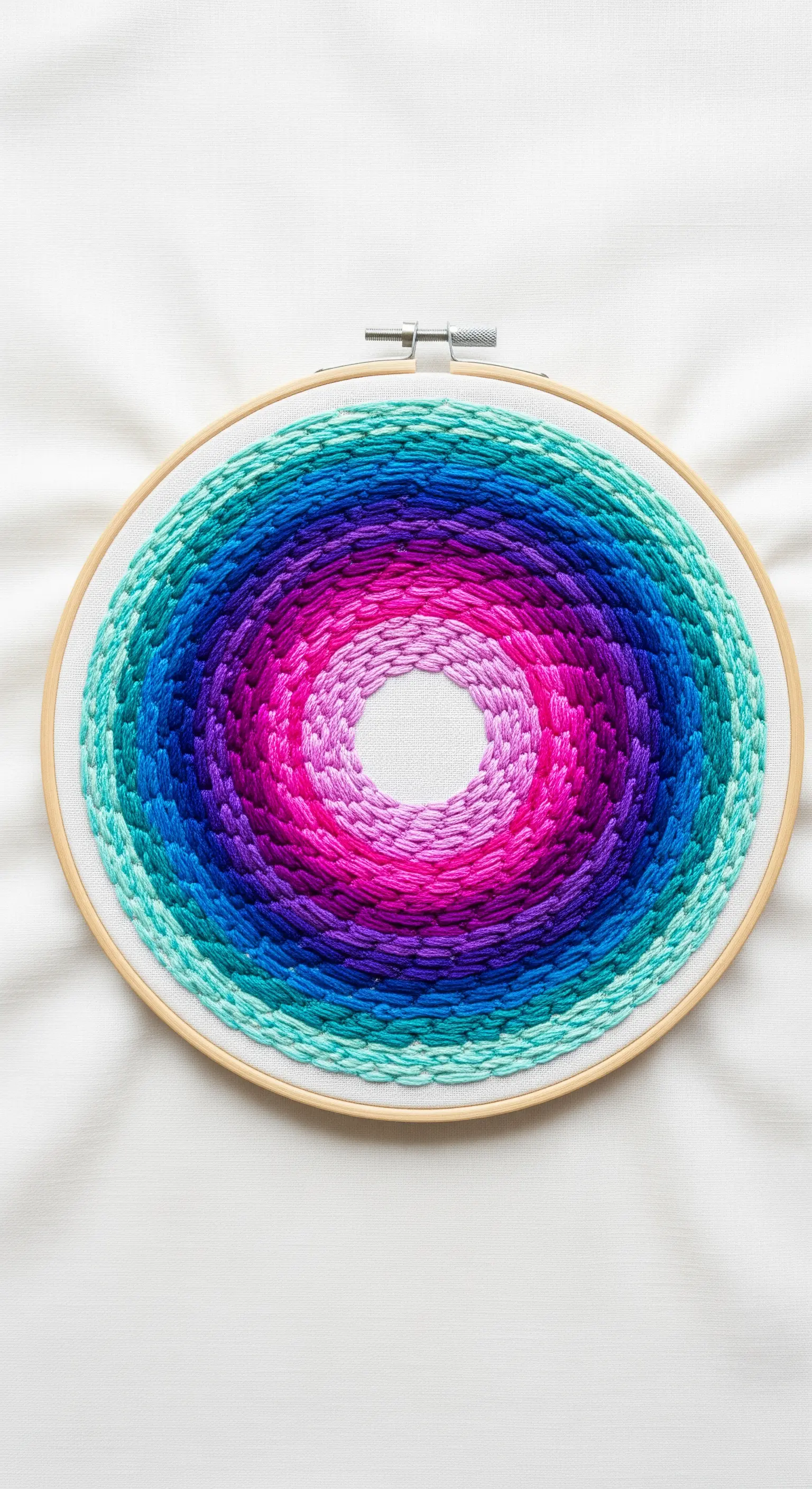 A circular color gradient in jewel tones created with textured brick stitch.