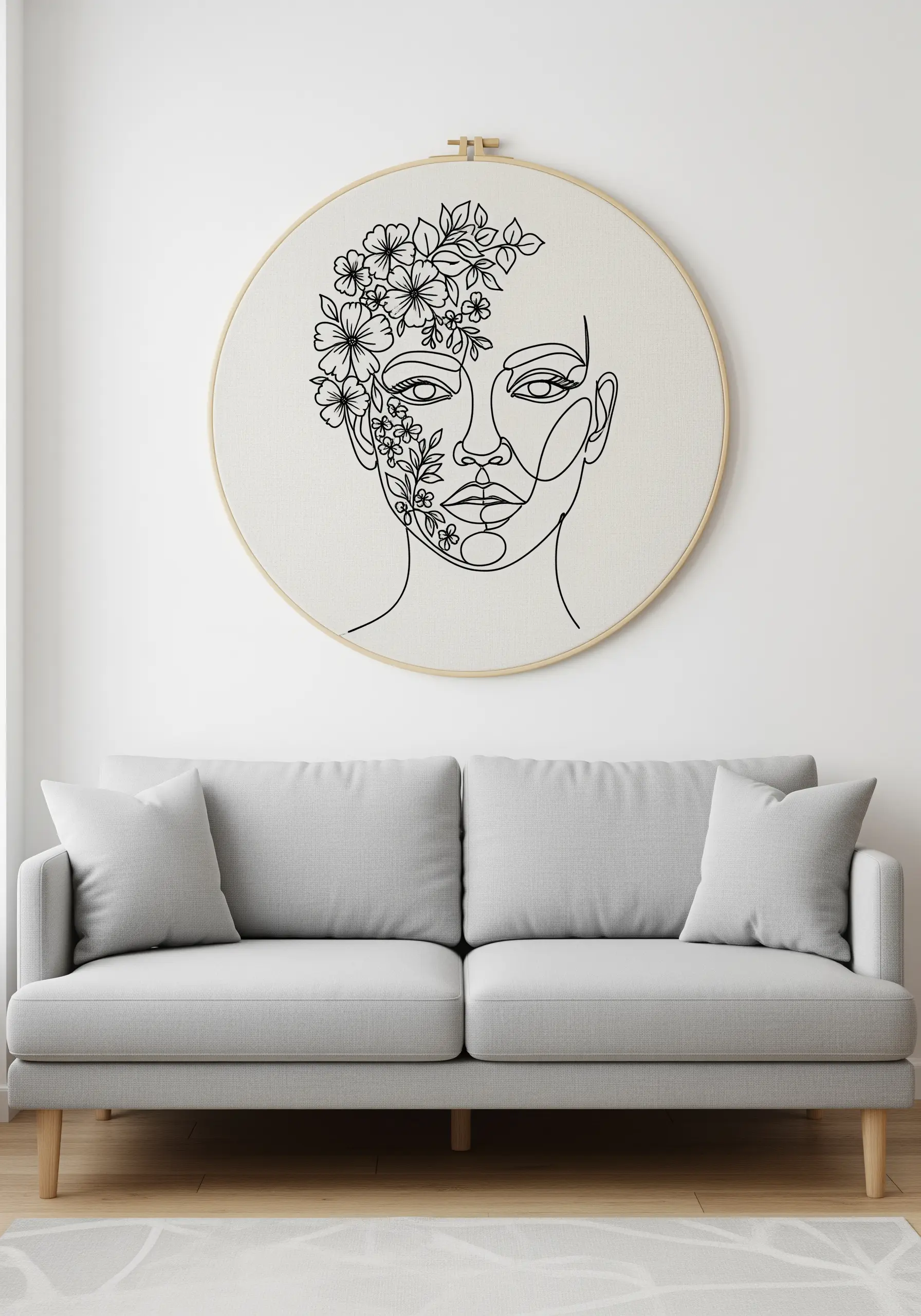 A large hoop with a line art face, where a cascade of black and white flowers emerges from one side.