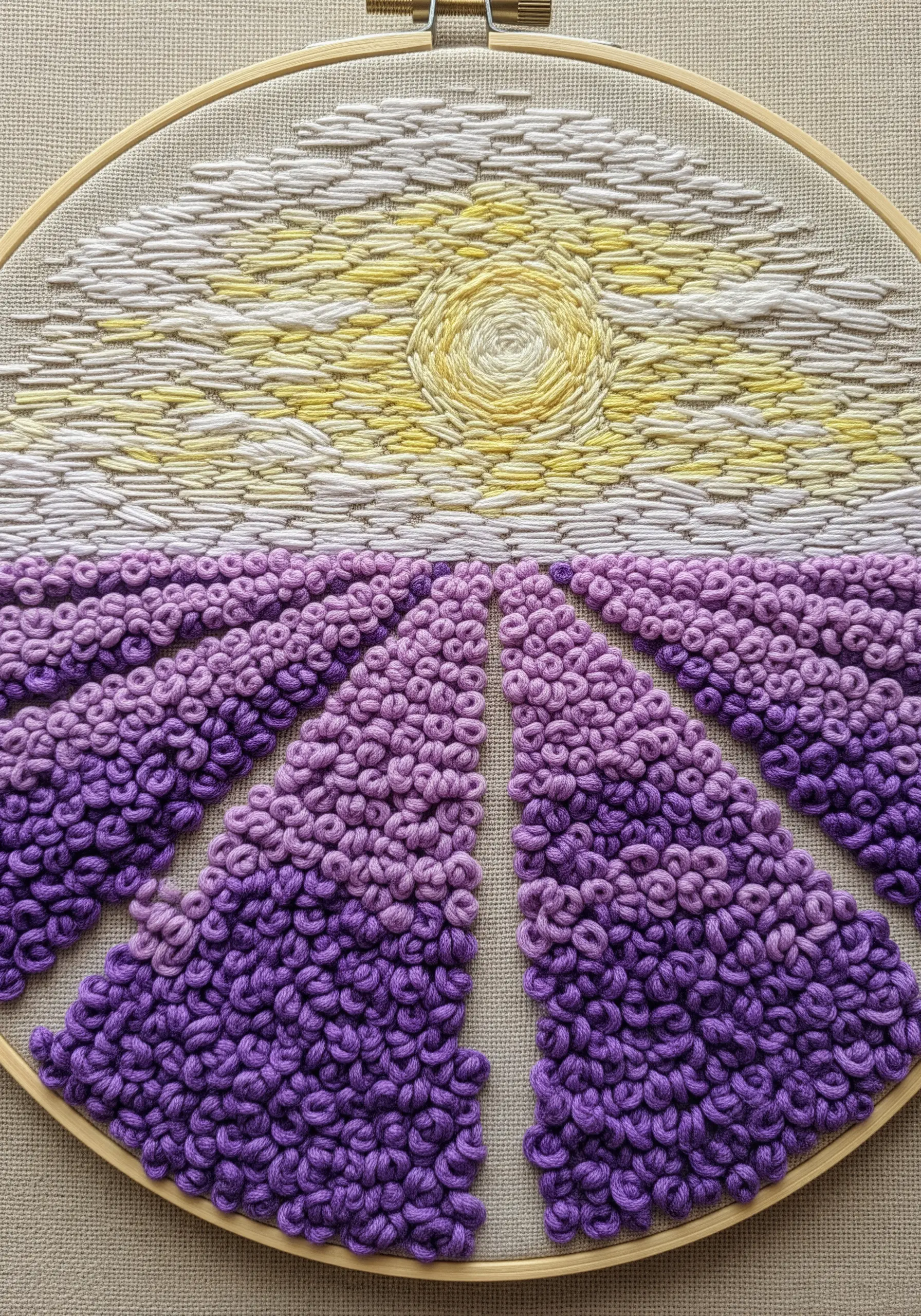 A lavender field landscape made with purple French knots and a yellow and white stitched sky.