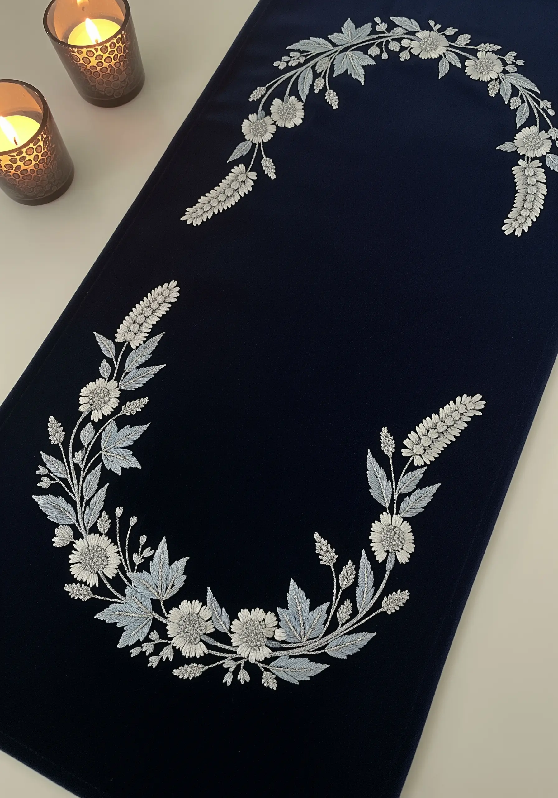 Silver and pale blue floral embroidery on a dark navy velvet table runner