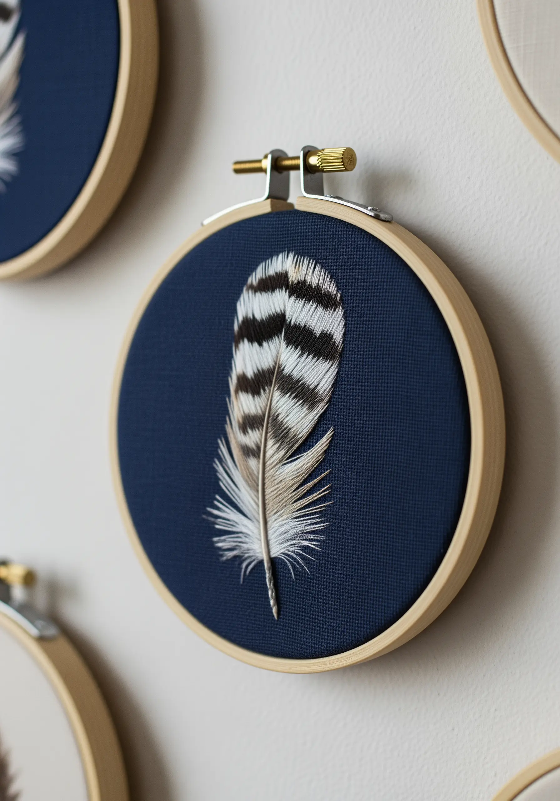 A hyper-realistic embroidered feather with fine details on a navy blue background.