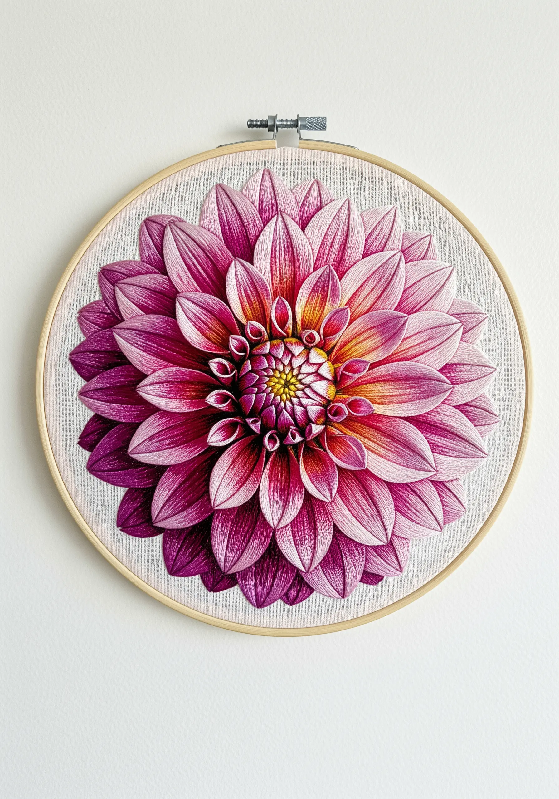 A hyper-realistic thread-painted dahlia with intricate pink and magenta petals in a wooden hoop.