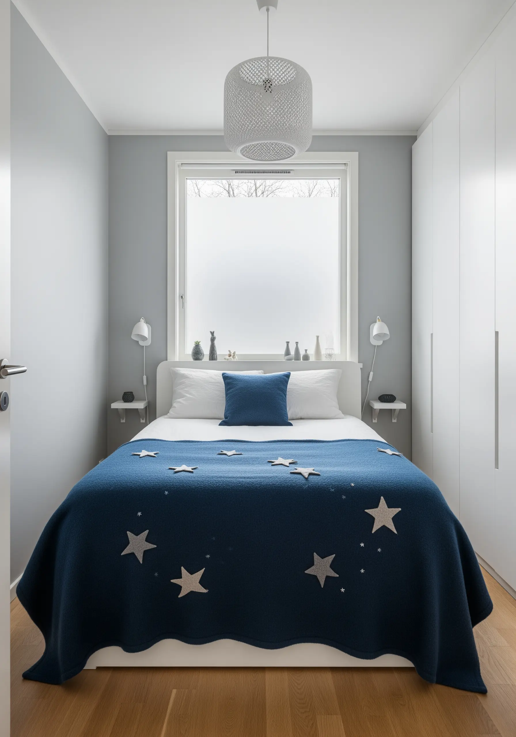 Felt appliqué stars in shades of grey and white stitched onto a dark blue wool blanket.