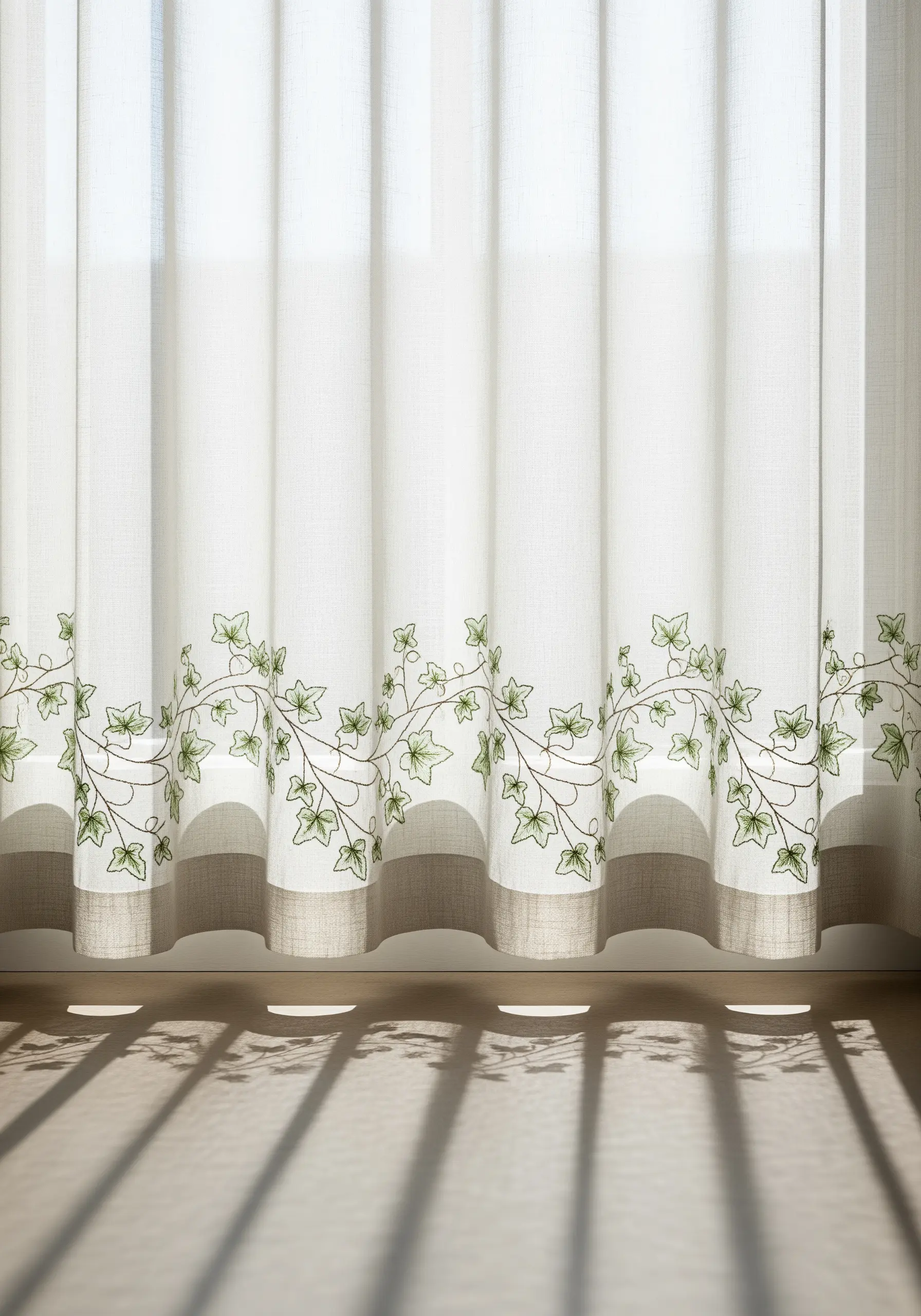 Sheer white curtains with a delicate embroidered border of green ivy vines.