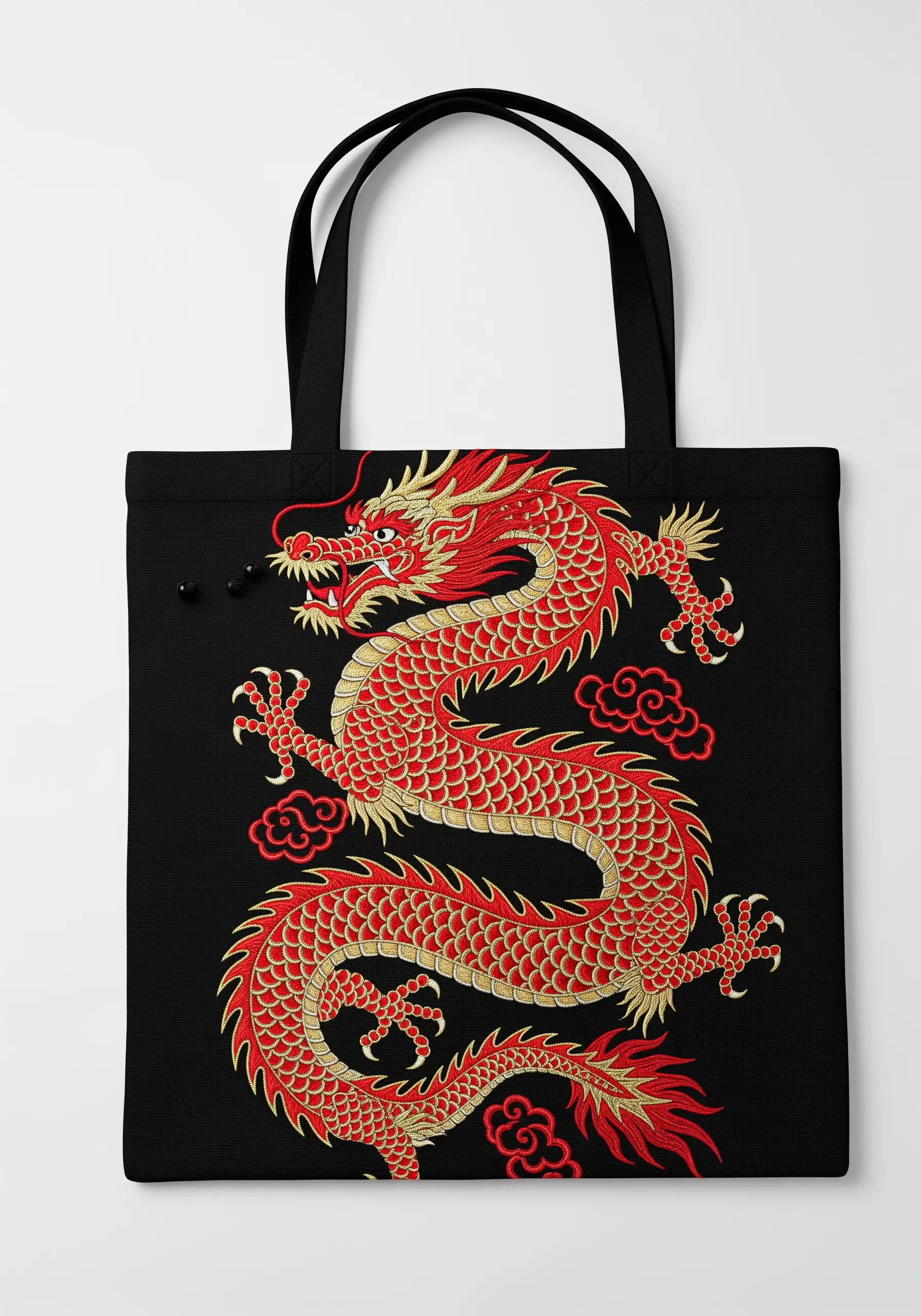 An intricate red and gold Chinese dragon embroidered on a black tote bag