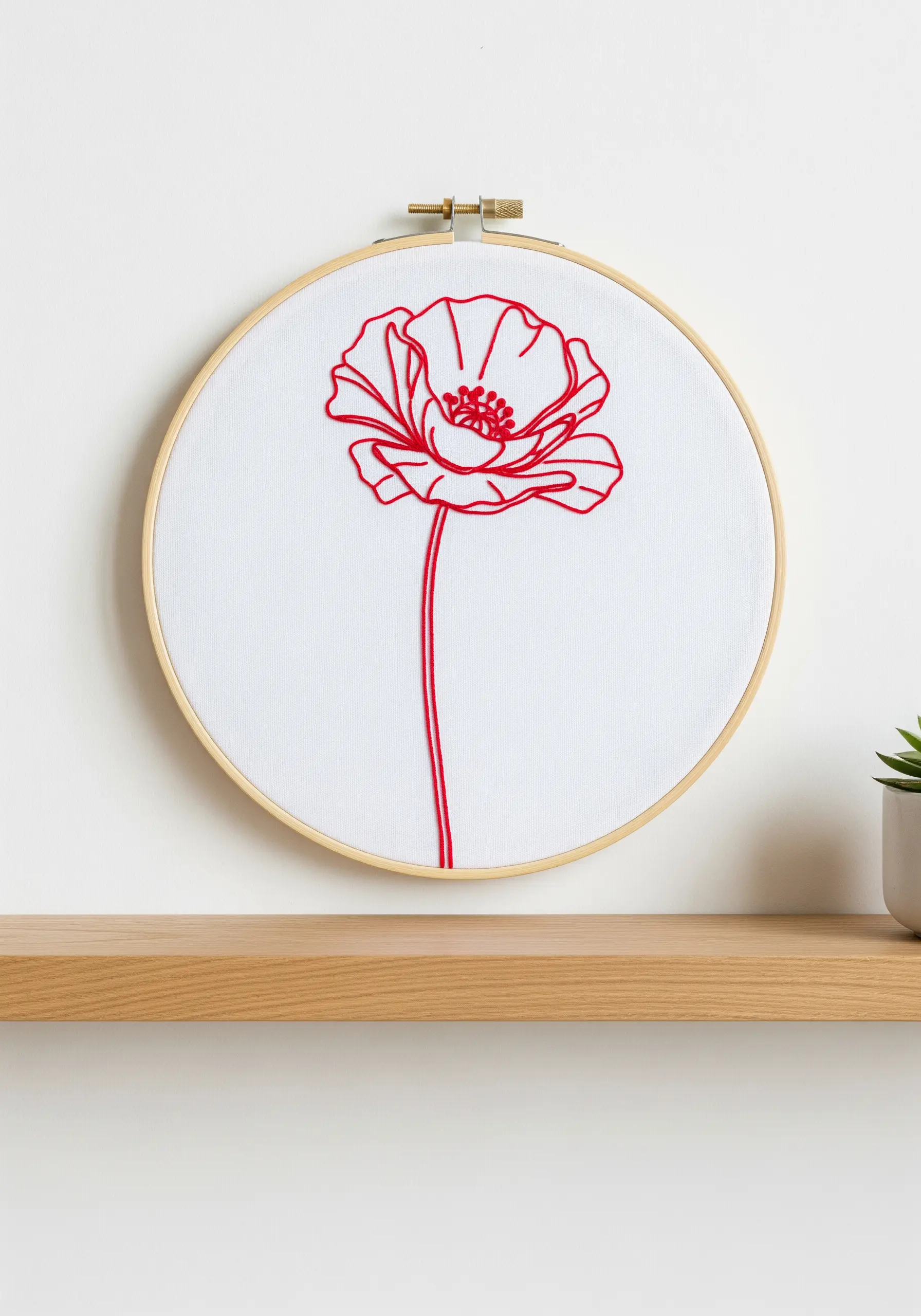 A vibrant red poppy flower with a long stem, embroidered in detailed line art.