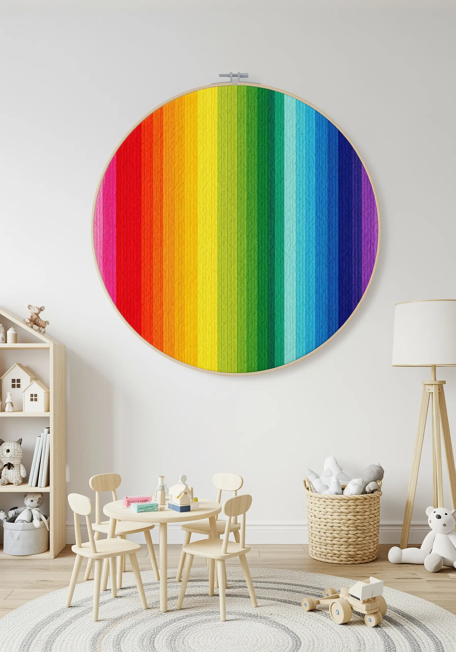 A large embroidery hoop completely filled with a vertical satin stitch rainbow gradient.