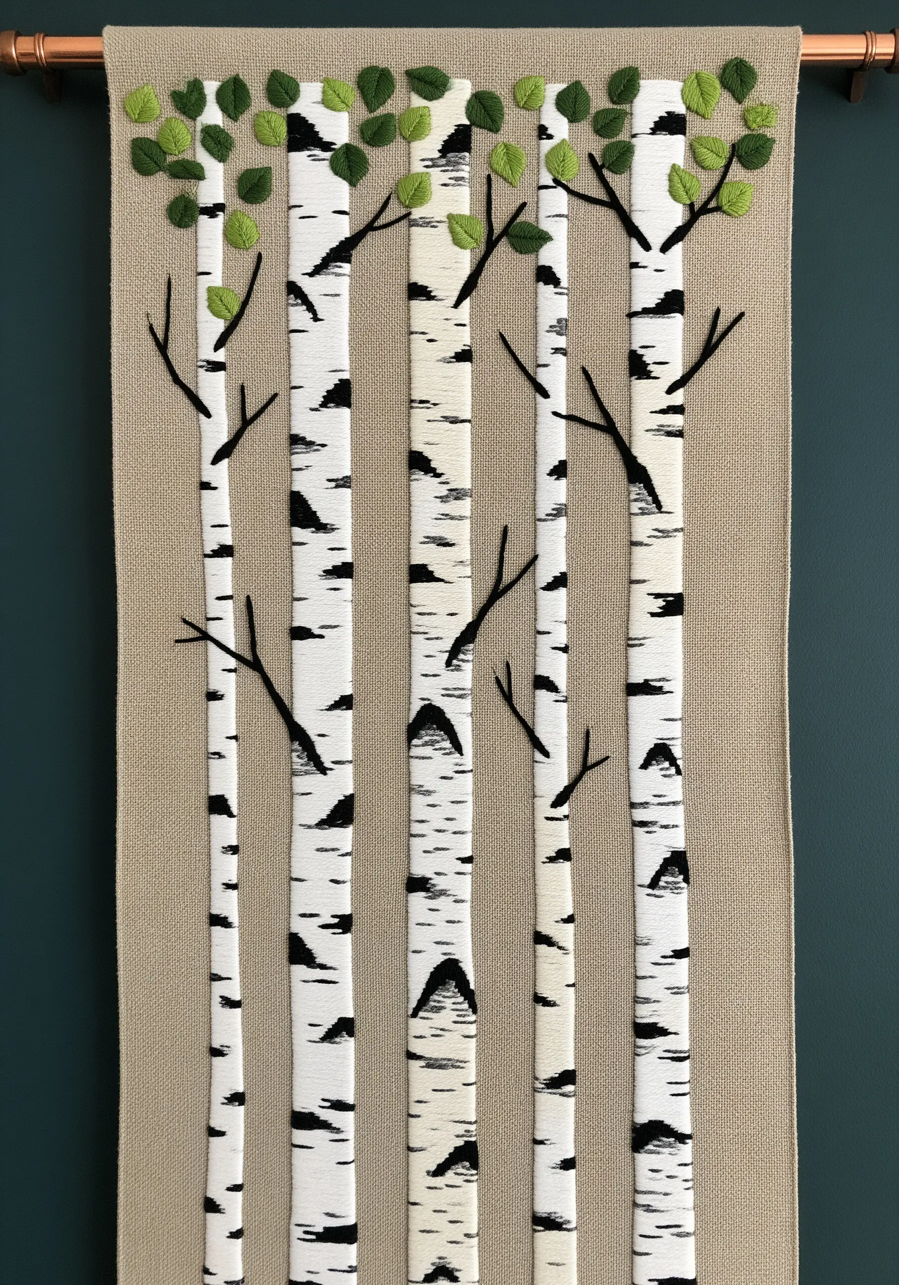 Wall hanging of birch trees made with appliqué and black embroidery.