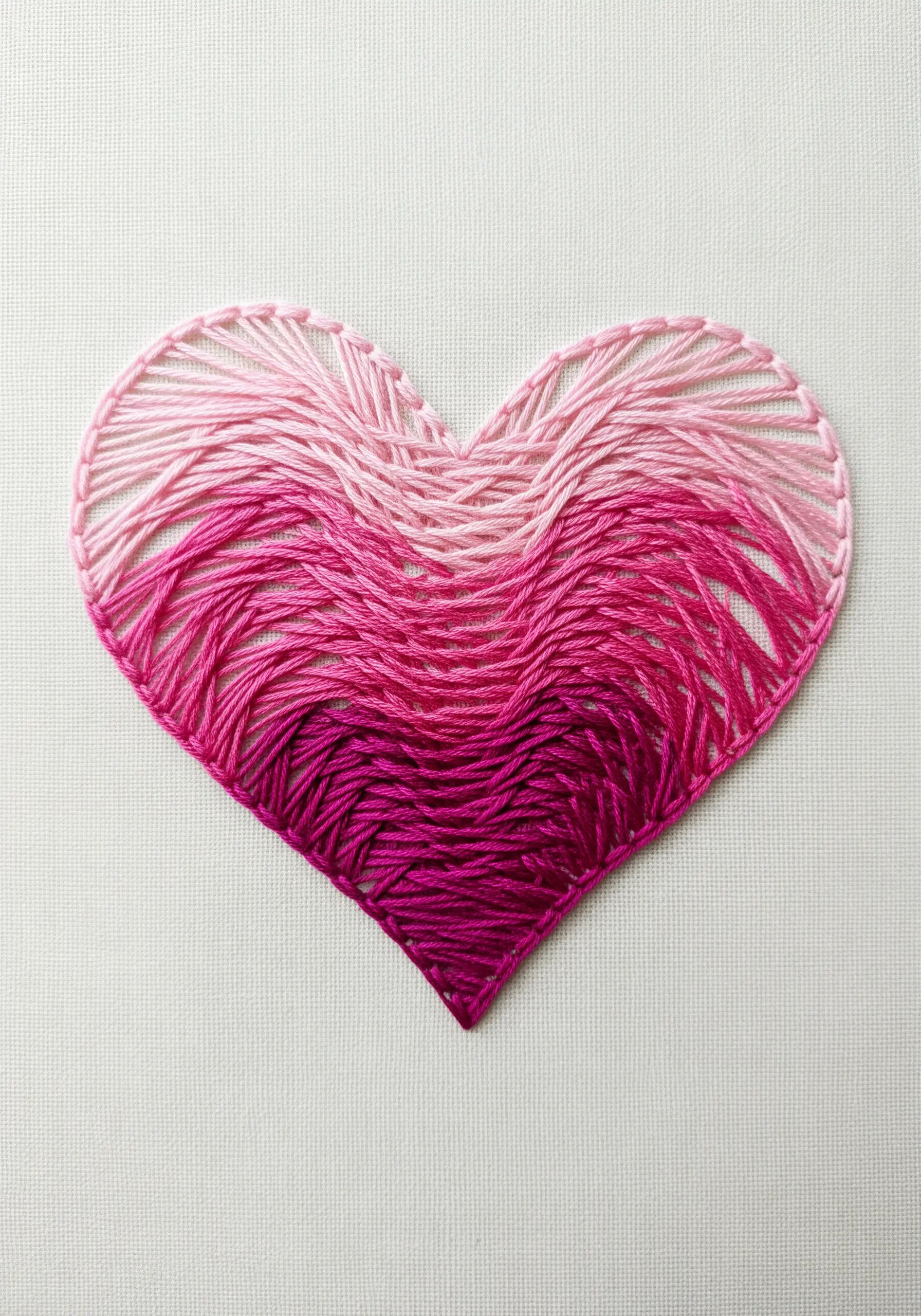An embroidered heart with a smooth pink-to-magenta ombré gradient fill.